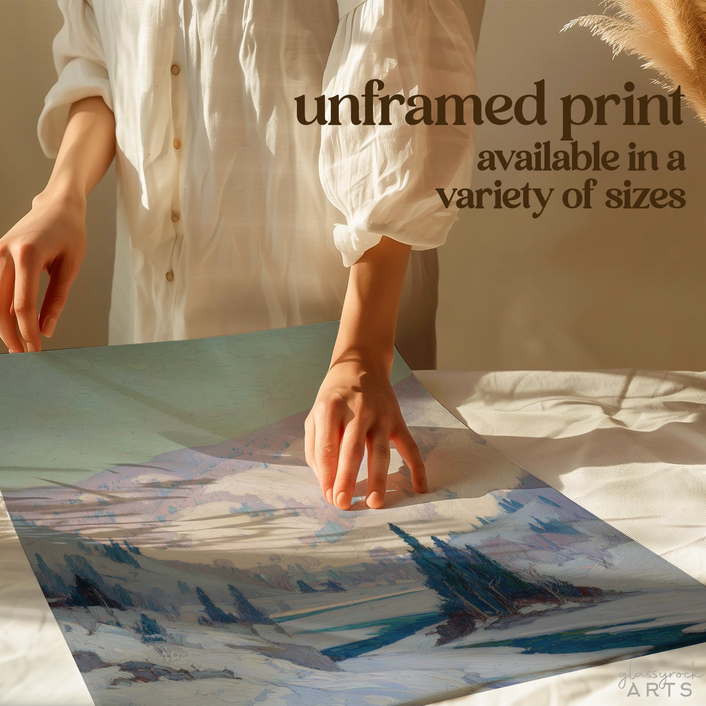 Person holding a piece of paper with a watercolor landscape, text overlay about unframed prints.