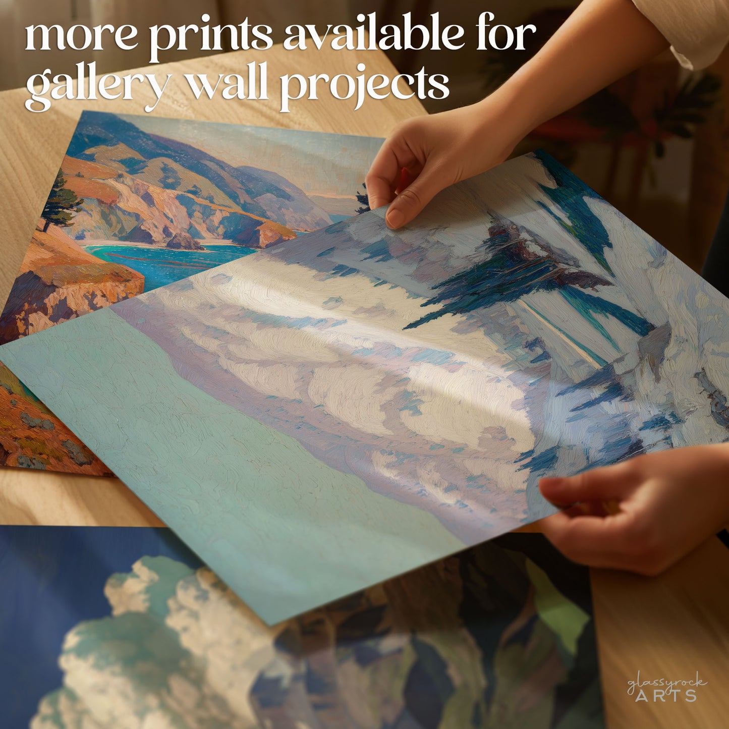 Person arranging scenic prints on a table with text about available prints for gallery wall projects.