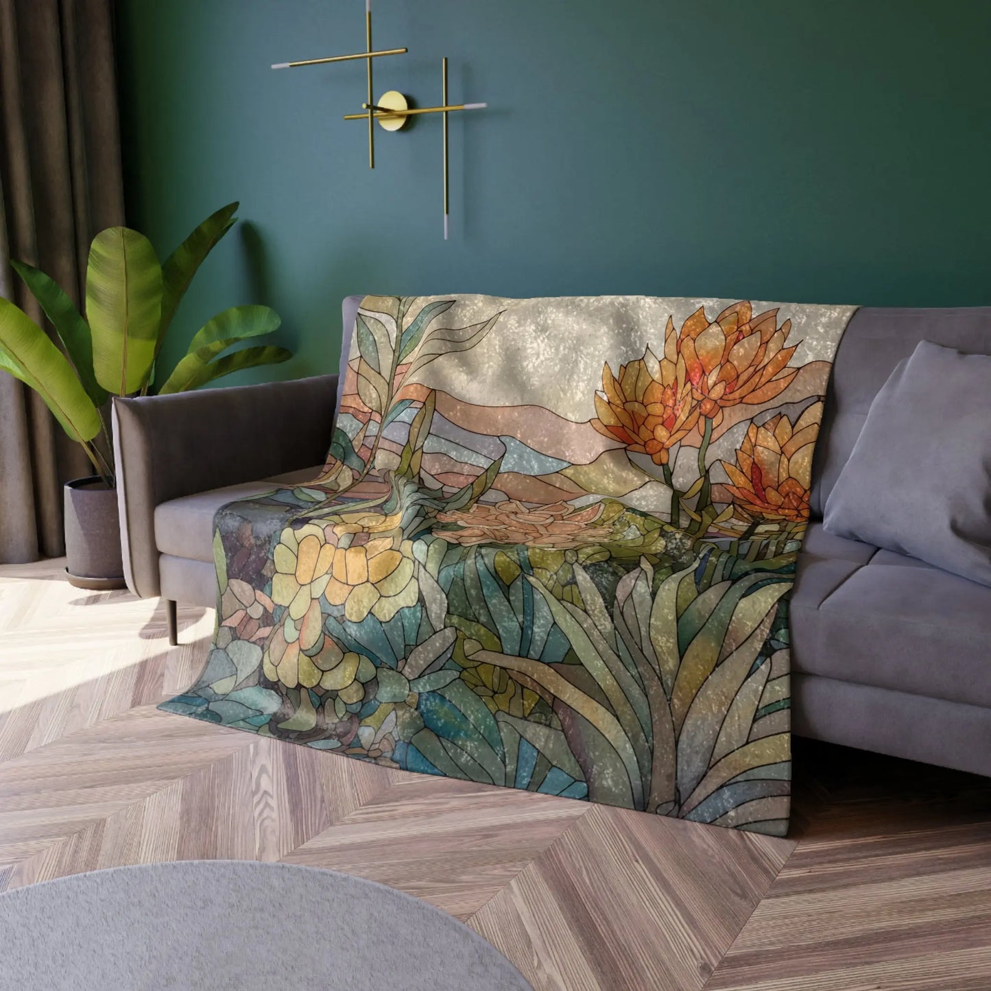 A cozy room features a couch draped with the Stained Glass Succulents Crushed Velvet Blanket. The vibrant floral design contrasts against a dark green wall adorned with a modern clock and lush plant, while a round gray rug on the wooden floor adds warmth and charm.