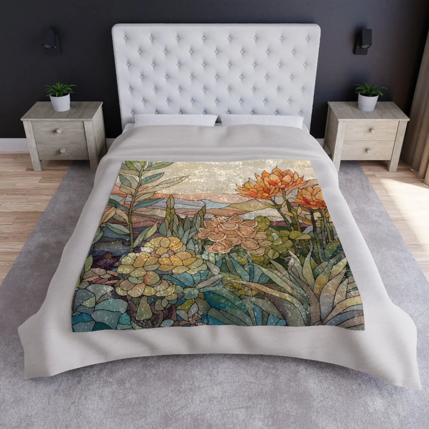A bed with a tufted white headboard is adorned with the Stained Glass Succulents Crushed Velvet Blanket - 50x60. This colorful, floral-themed quilt displays various plants and flowers in earthy tones, complementing a modern bedroom featuring two bedside tables and a gray carpeted floor.