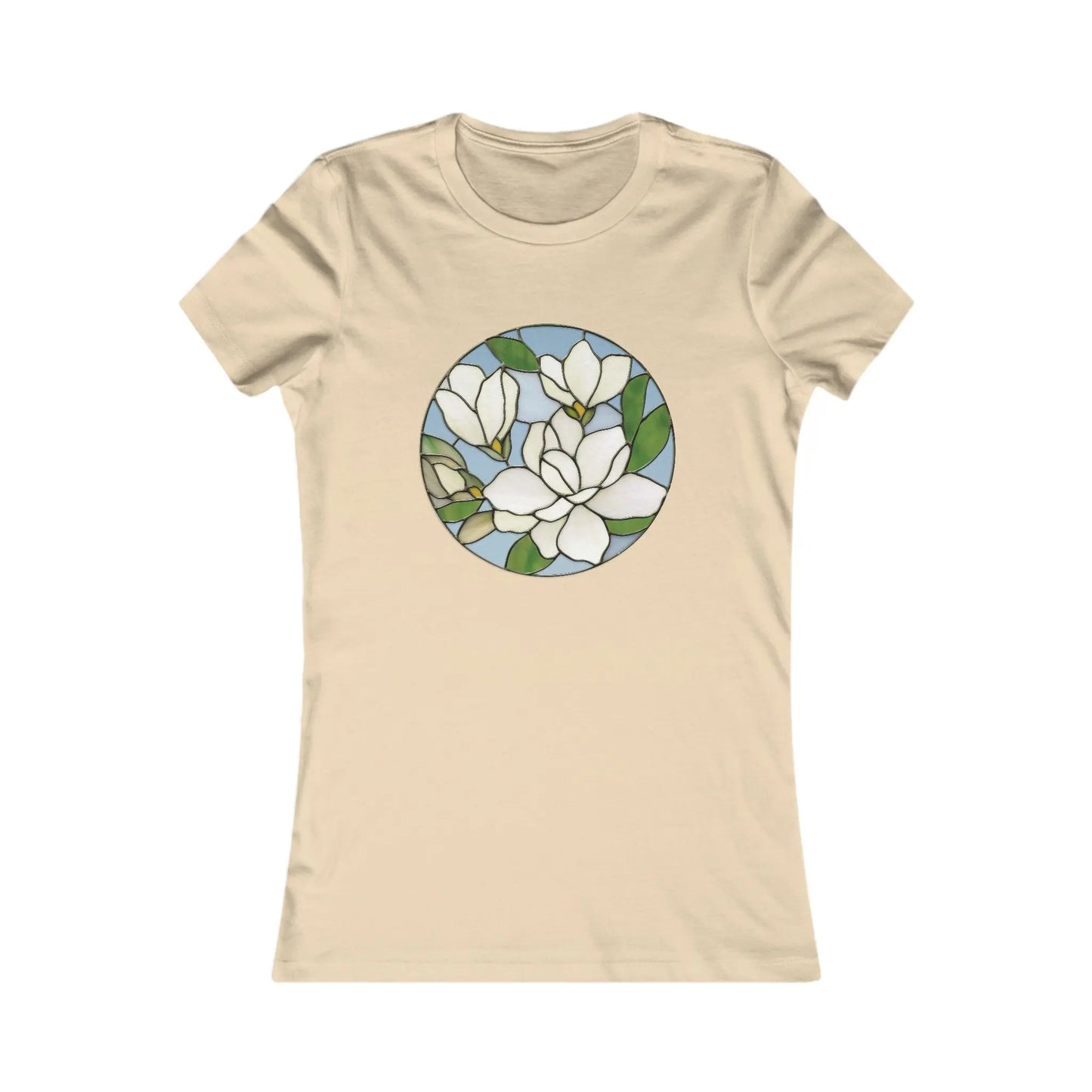 The Stained Glass Magnolia Womens Tee Shirt offers comfort with a beige hue and circular stained glass design featuring white magnolia flowers, green leaves, and a light blue background, combining style with sustainable fashion charm.