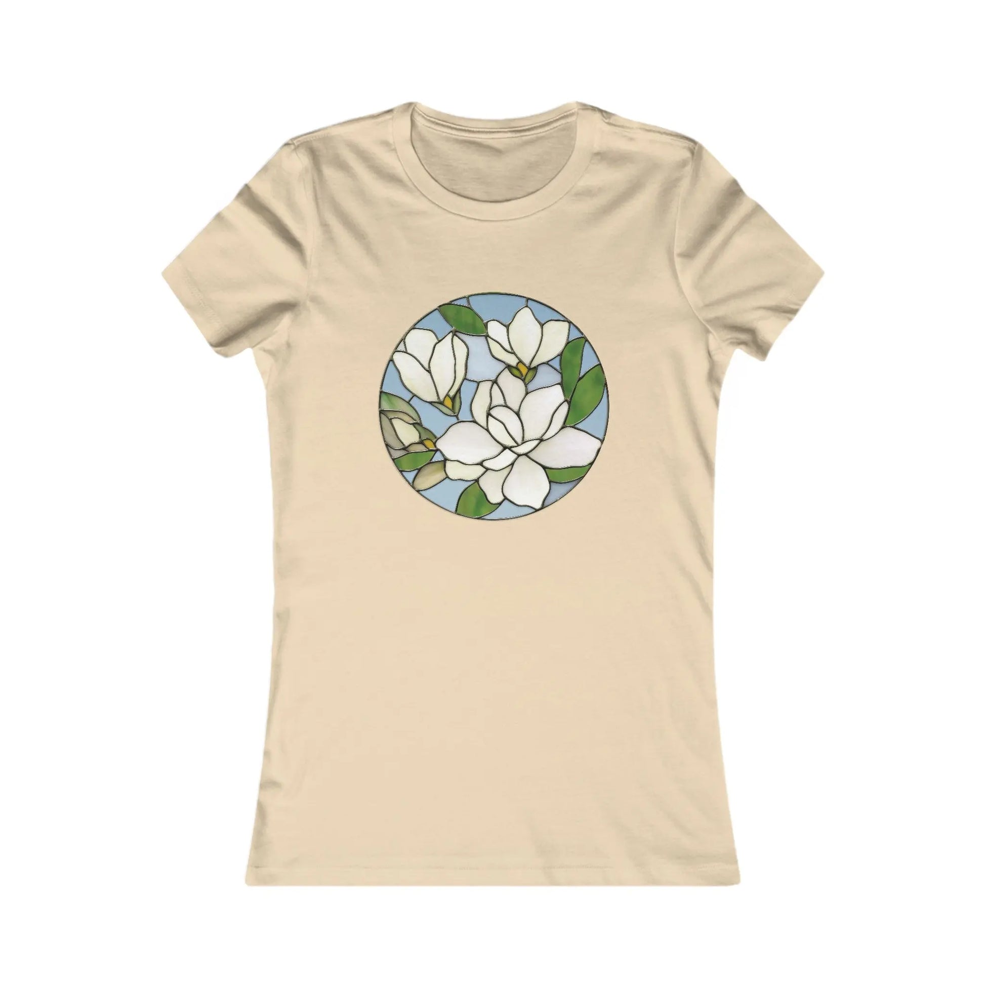 The Stained Glass Magnolia Womens Tee Shirt offers comfort with a beige hue and circular stained glass design featuring white magnolia flowers, green leaves, and a light blue background, combining style with sustainable fashion charm.