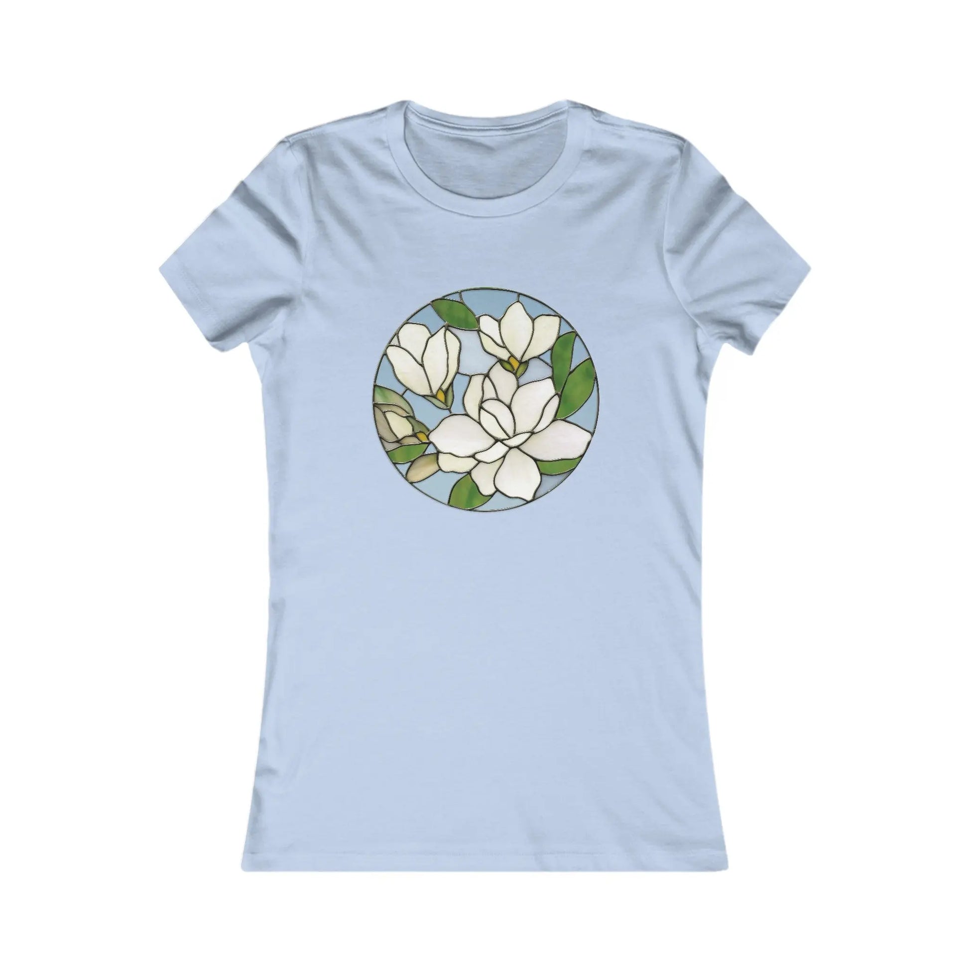 The Stained Glass Magnolia Womens Tee Shirt is a light blue, comfortable top featuring a round stained glass design with white flowers and green leaves, ideal for highlighting sustainable fashion.