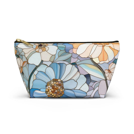 The Stained Glass Flowers Cosmetic Bag is a flat bottom bag with a gold zipper, showcasing large blue, white, and peach flowers. The centers are small brown and beige circles on a white background—ideal as a unique boho gift.