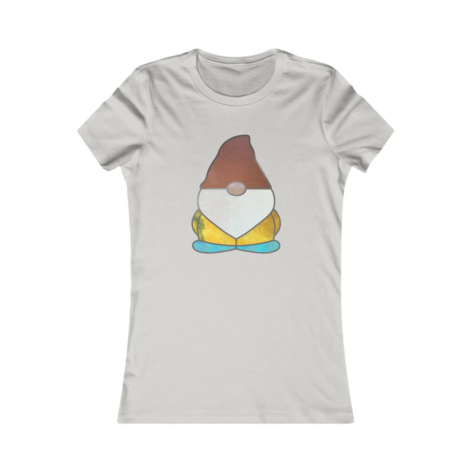The Stained Glass Gnome Womens Tee Shirt is sustainable and light gray, featuring a cartoon gnome with stained glass design. The gnome wears a brown hat, white beard, yellow outfit, and blue shoes on the plain backdrop.