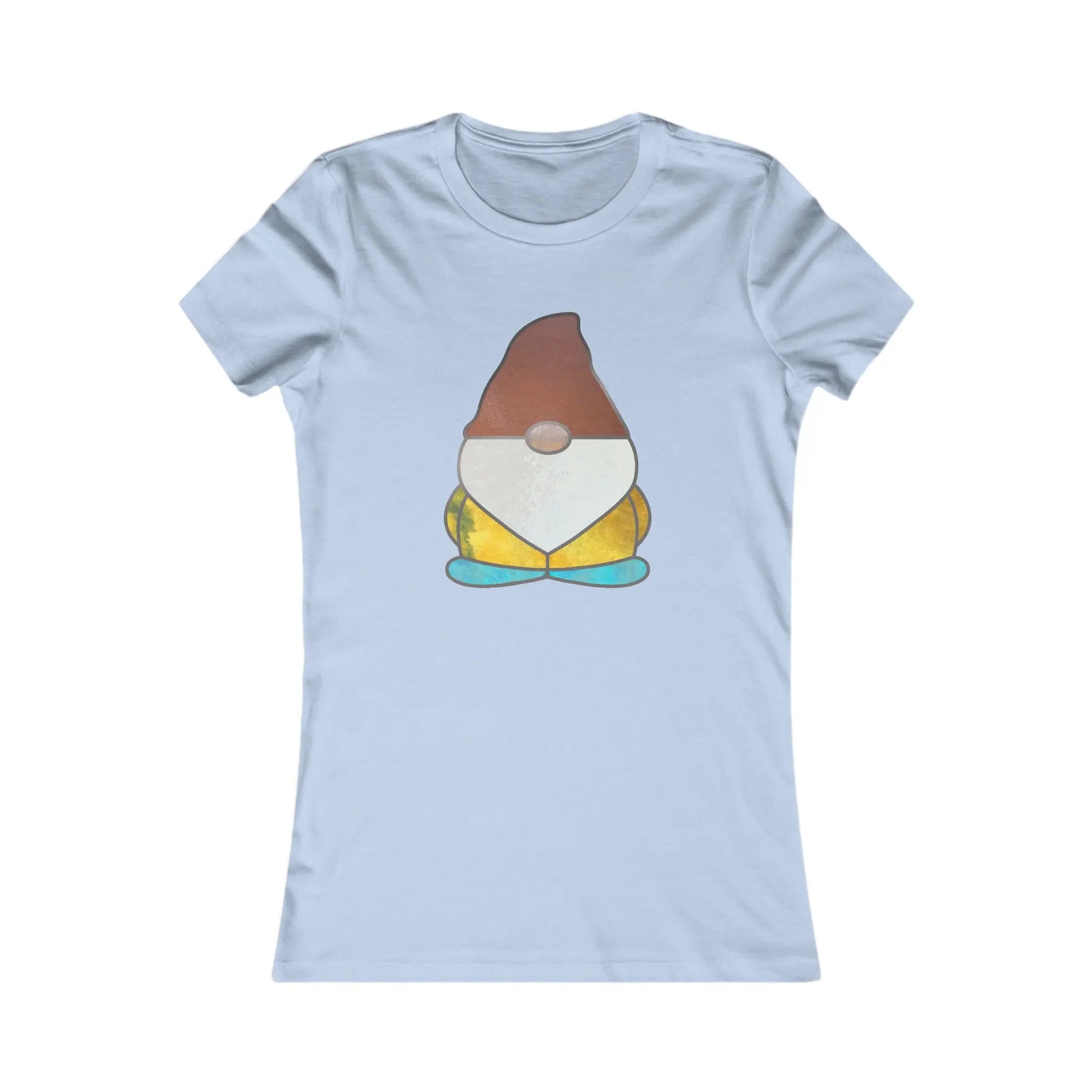 The Stained Glass Gnome Womens Tee Shirt features a sustainable light blue design with a gnome wearing a brown hat, white beard, yellow shirt, and turquoise shoes, highlighting a style that evokes stained glass artistry.