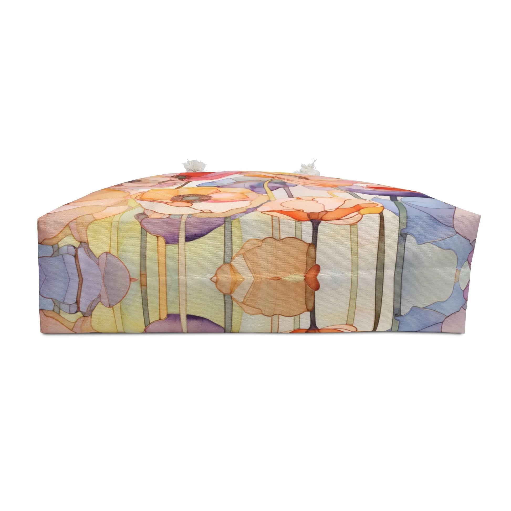 The Stained Glass Rainbow Poppies Oversized Tote Bag features a colorful abstract floral pattern in pastel orange, purple, blue, and green. It resembles stained glass with poppy flowers and has sturdy rope handles for easy carrying.