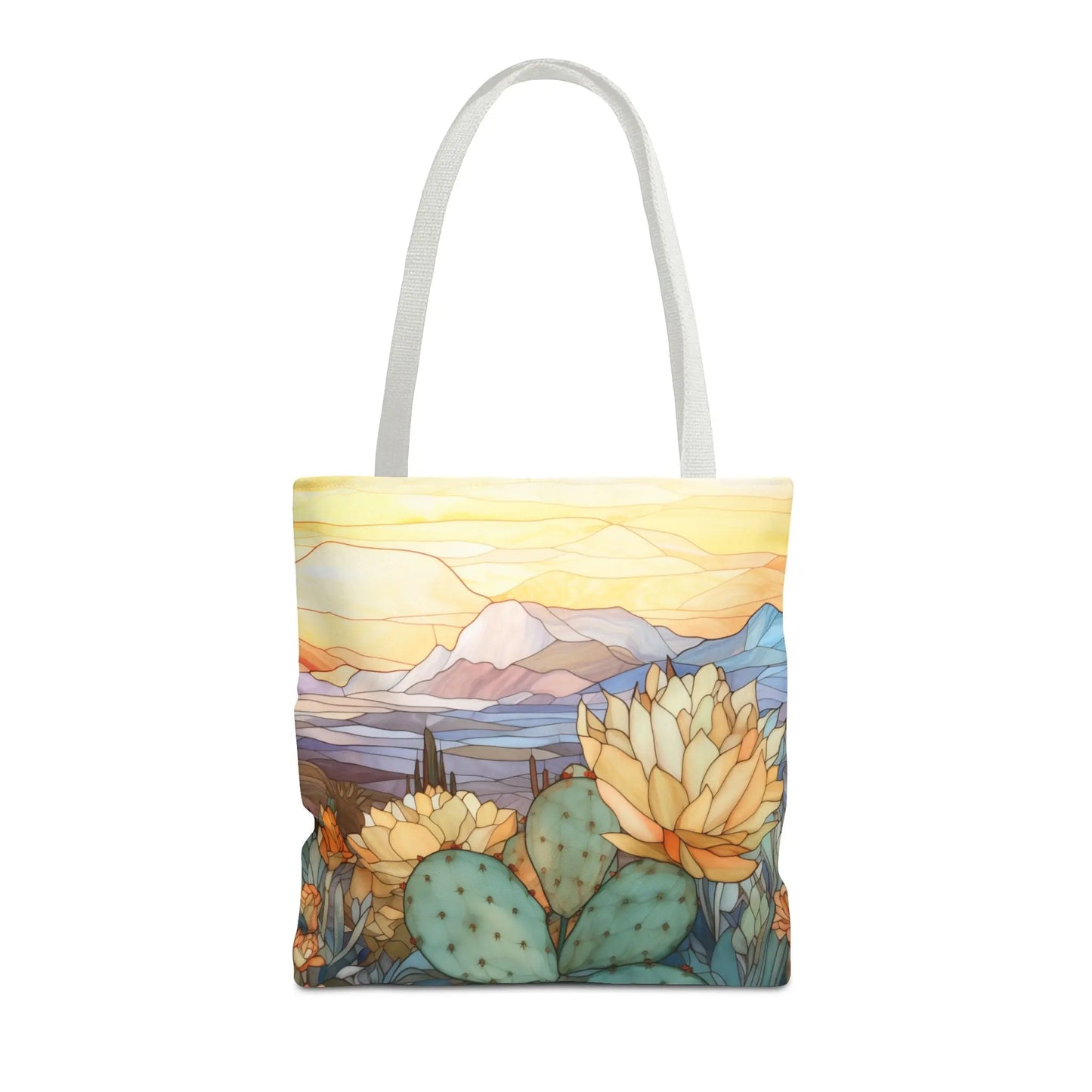 The Stained Glass Desert Cactus Tote Bag, offered in three sizes, features an artistically original desert scene with blooming cacti and mountains under a sunset. Made from durable polyester, its design showcases orange and yellow hues transitioning into soft blues for a warm, serene landscape.