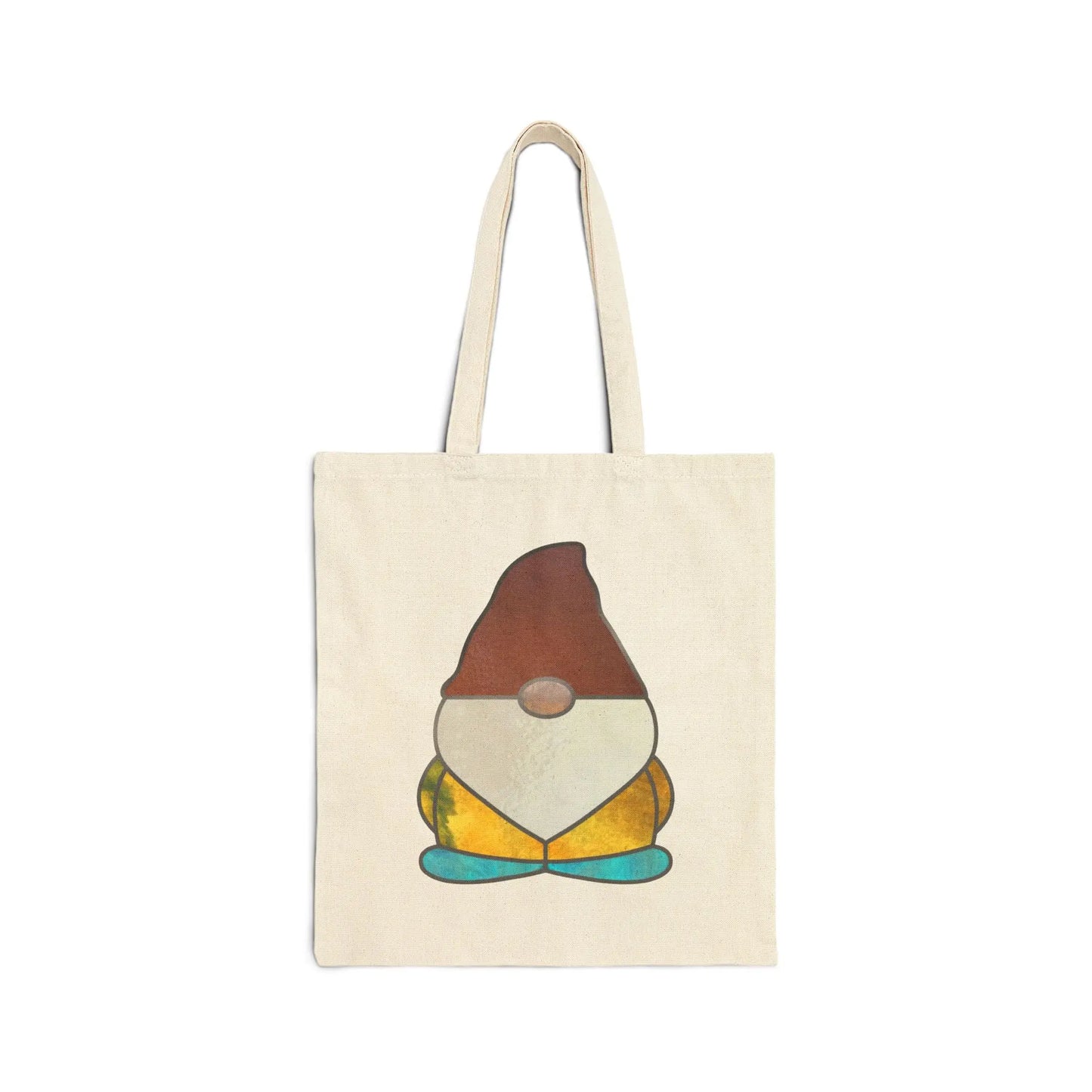 The Stained Glass Gnome Cotton Canvas Tote Bag features beige cotton canvas with original artwork of a quirky gnome, donning a brown hat, round nose, and teal shoes. The gnomes orange and yellow outfit mimics a stained glass design as it sits cross-legged.