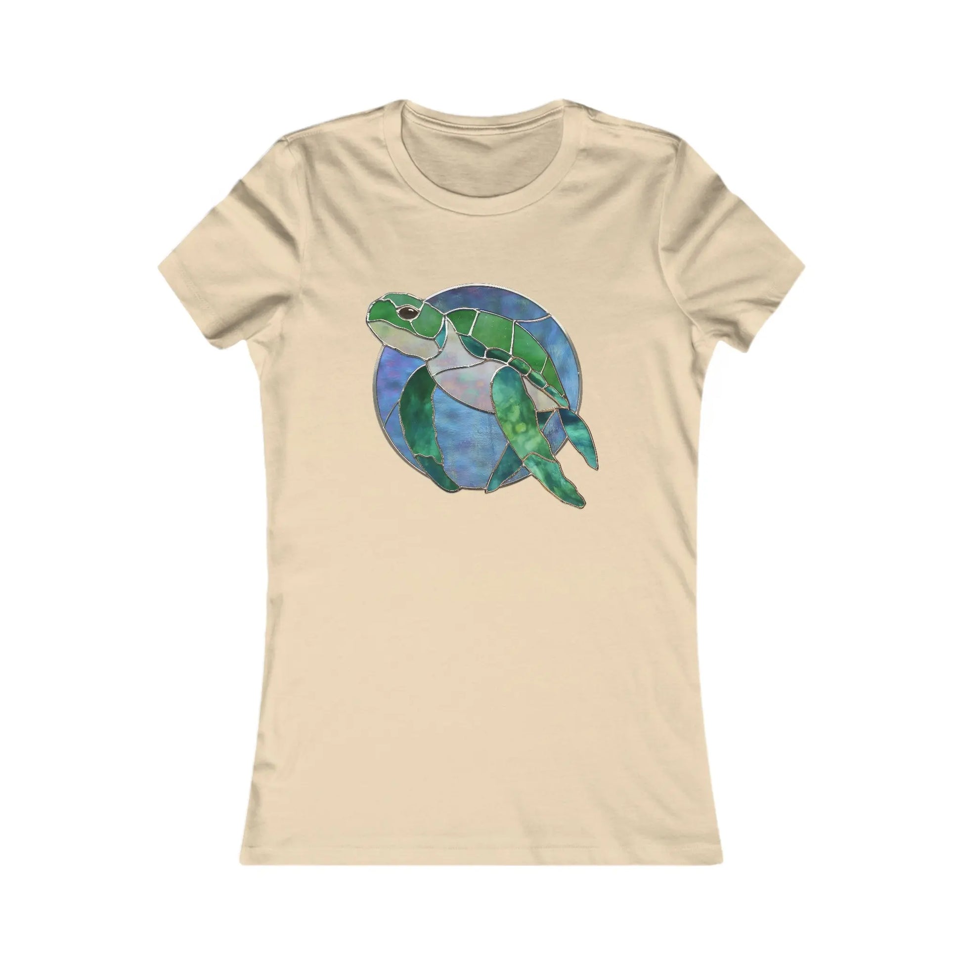 A beige Womens Tee Shirt features a stunning stained glass-style illustration of a green sea turtle swimming in a blue and purple circular background. Part of our sustainable fashion line, each Stained Glass Turtle shirt is made on demand to ensure minimal waste. The shirt is laid flat.