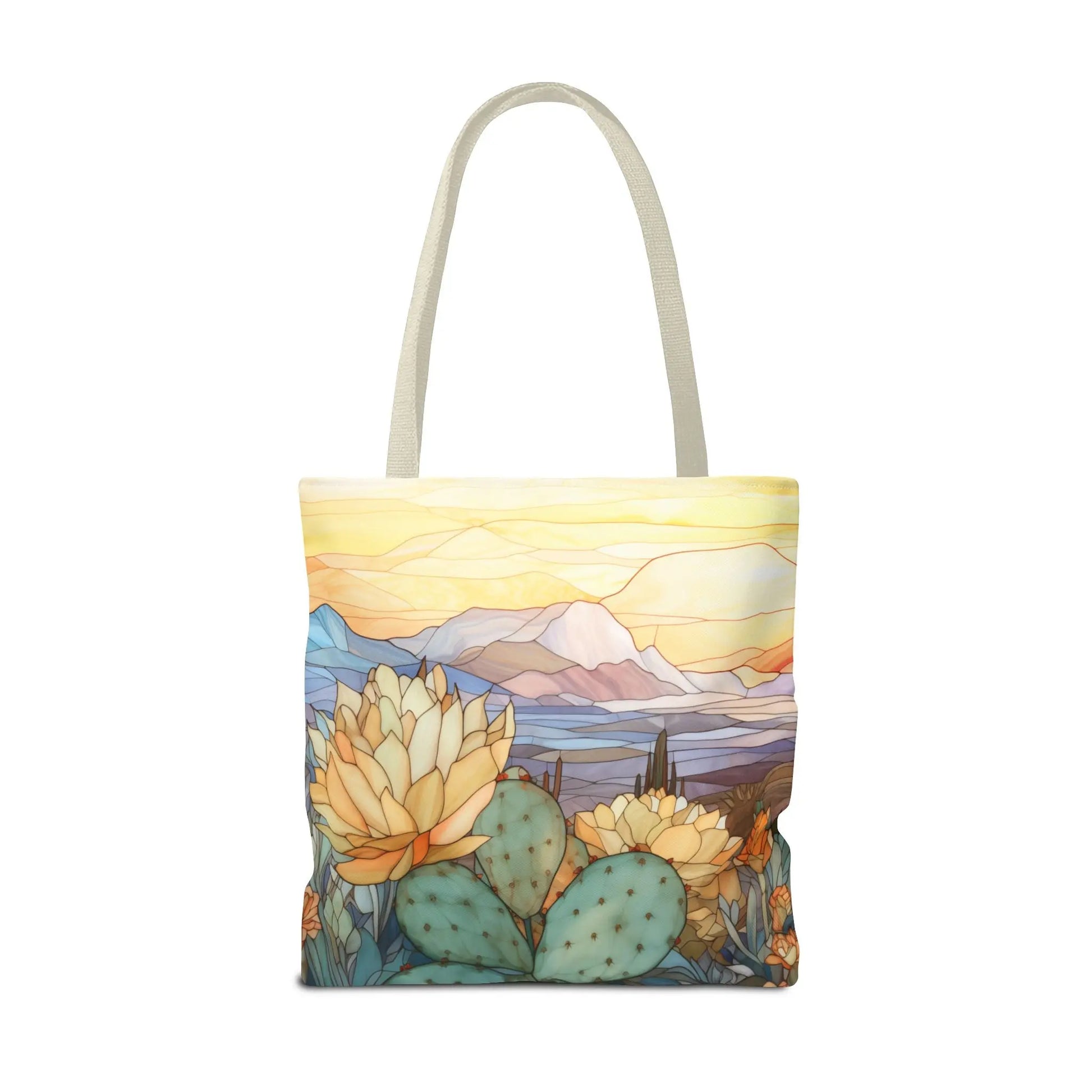 The Stained Glass Desert Cactus Tote Bag, available in 3 sizes, features a durable polyester build with an original design depicting a colorful landscape of cacti, flowers in the foreground, and vibrant mountains against a glowing sky.