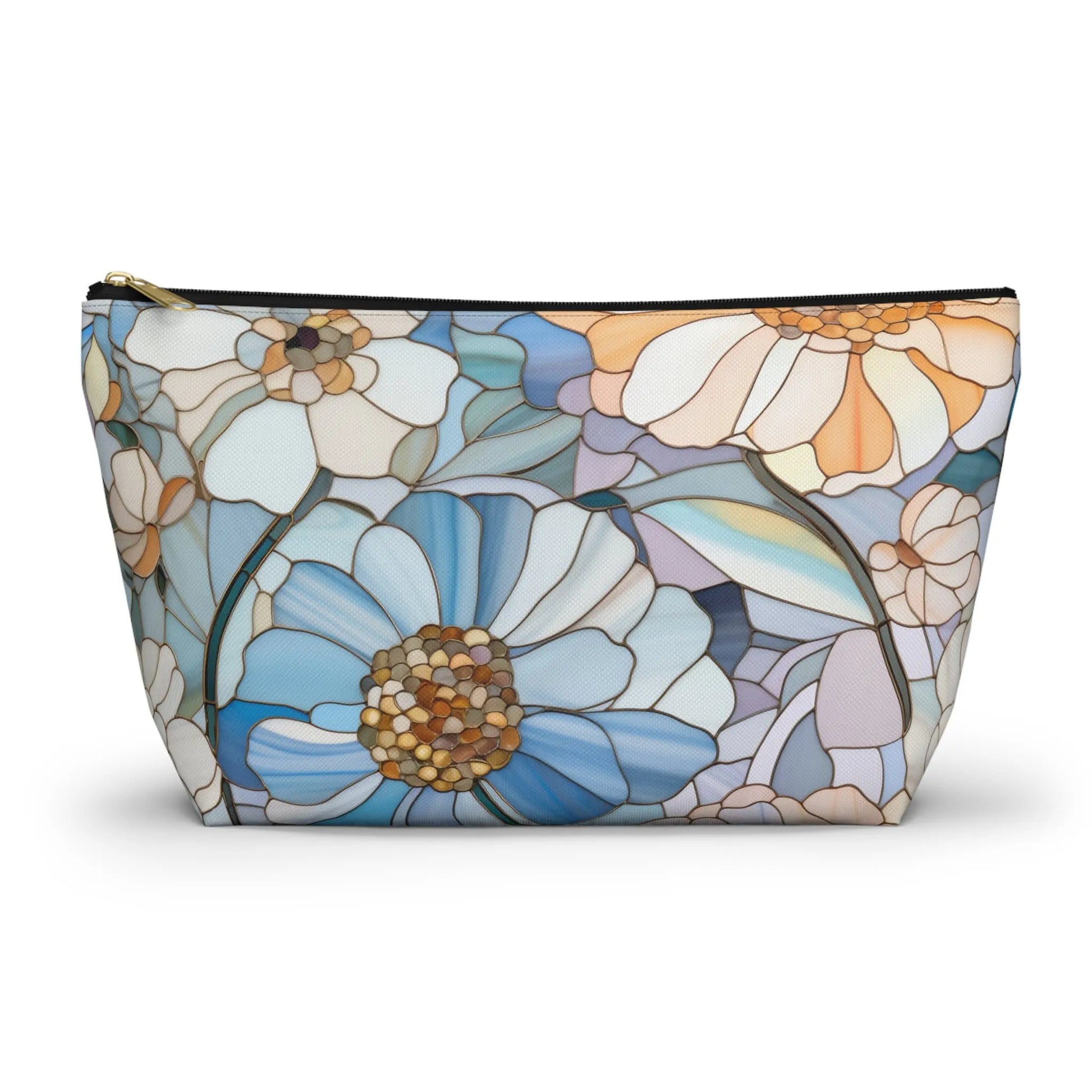 The Stained Glass Flowers Cosmetic Bag features a flat bottom and zipper, adorned with a stained glass pattern of large blue, white, and yellow flowers with green leaves. It adds an elegant touch to your boho collection.