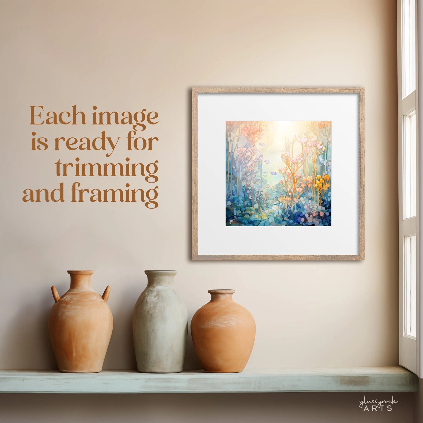 The 2025 Ocean Life Large Wall Calendar, with its framed abstract floral patterns evoking ocean themes, is displayed on a beige wall. Text states Each image is ready for trimming and framing. Below, a shelf holds three neutral-toned decorative vases as sunlight filters through a nearby window.