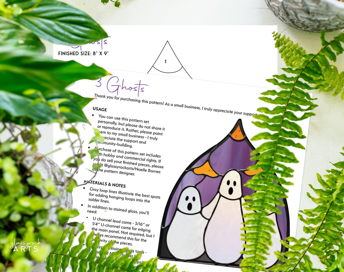 The Three Ghosts Halloween Stained Glass Pattern is a digital sewing pattern featuring three cartoon ghosts in a purple pumpkin-shaped frame surrounded by leaves and a plant. It includes usage instructions, material details, and a template piece.