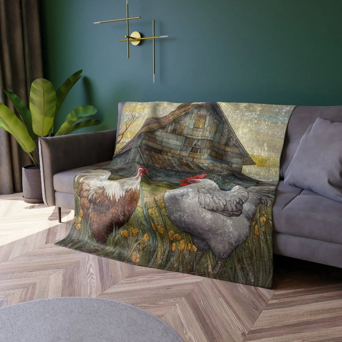 In a cozy living room, a sofa is adorned with the Stained Glass Chickens Crushed Velvet & Fleece Blanket - 50x60 featuring an artistic farm scene with two roosters near a barn. The room has green walls, a floor lamp, and a potted plant beside the sofa.
