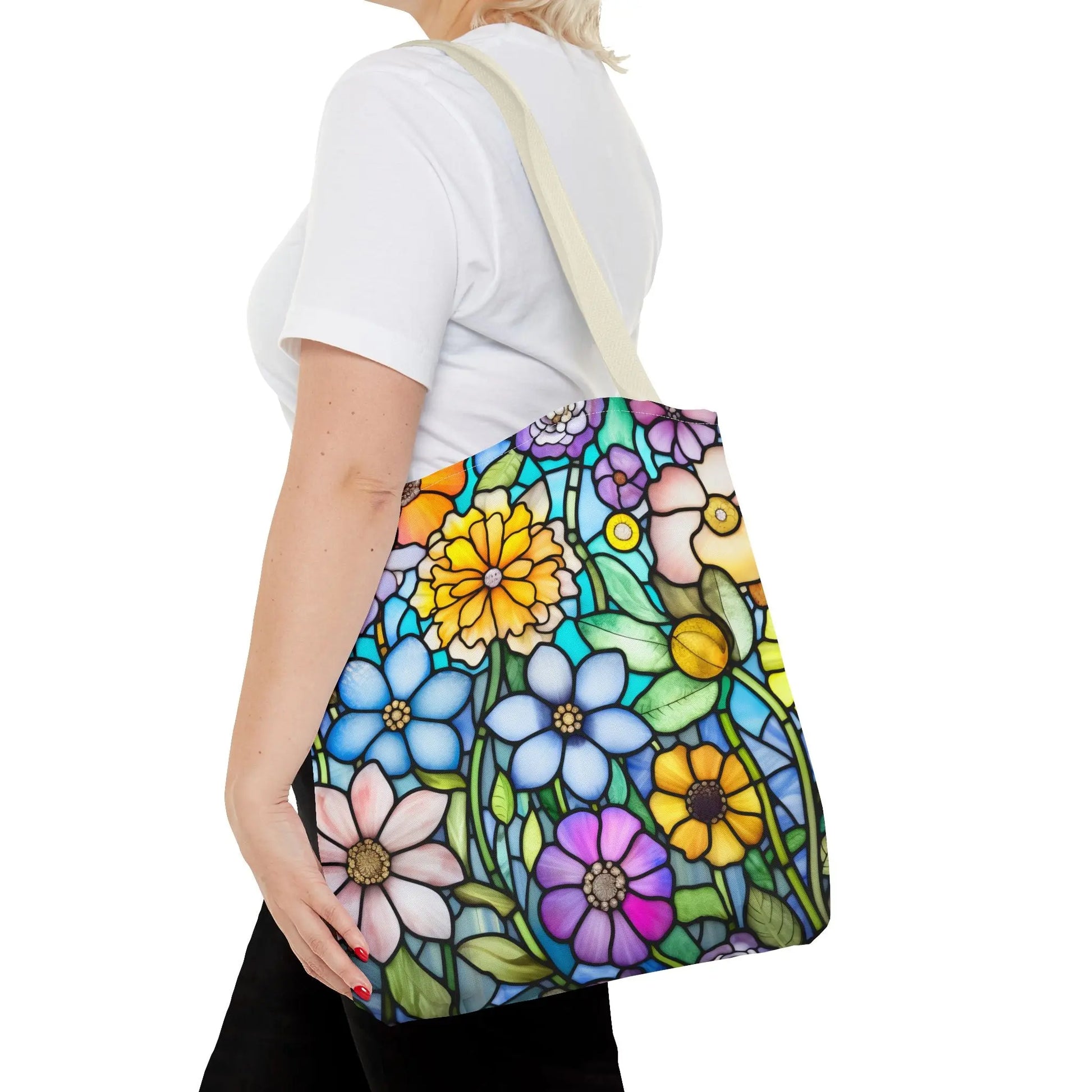 A person in a white shirt carries the Stained Glass Folk Art Flowers Tote Bag, crafted from durable polyester and featuring an original design with vibrant floral patterns.