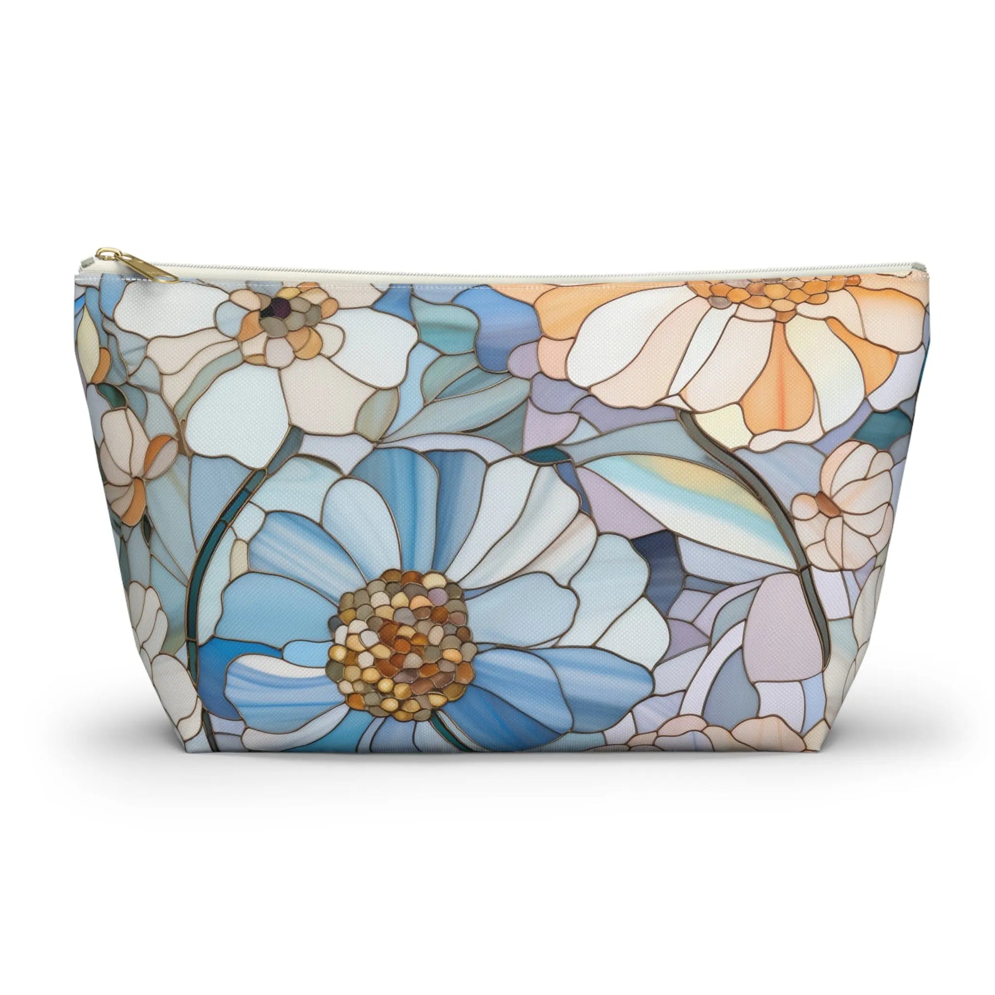 The Stained Glass Flowers Cosmetic Bag features a flat bottom with a stained glass floral design in white, blue, and beige. Its mosaic-like pattern adds an elegant, artistic flair, making it an ideal boho gift.