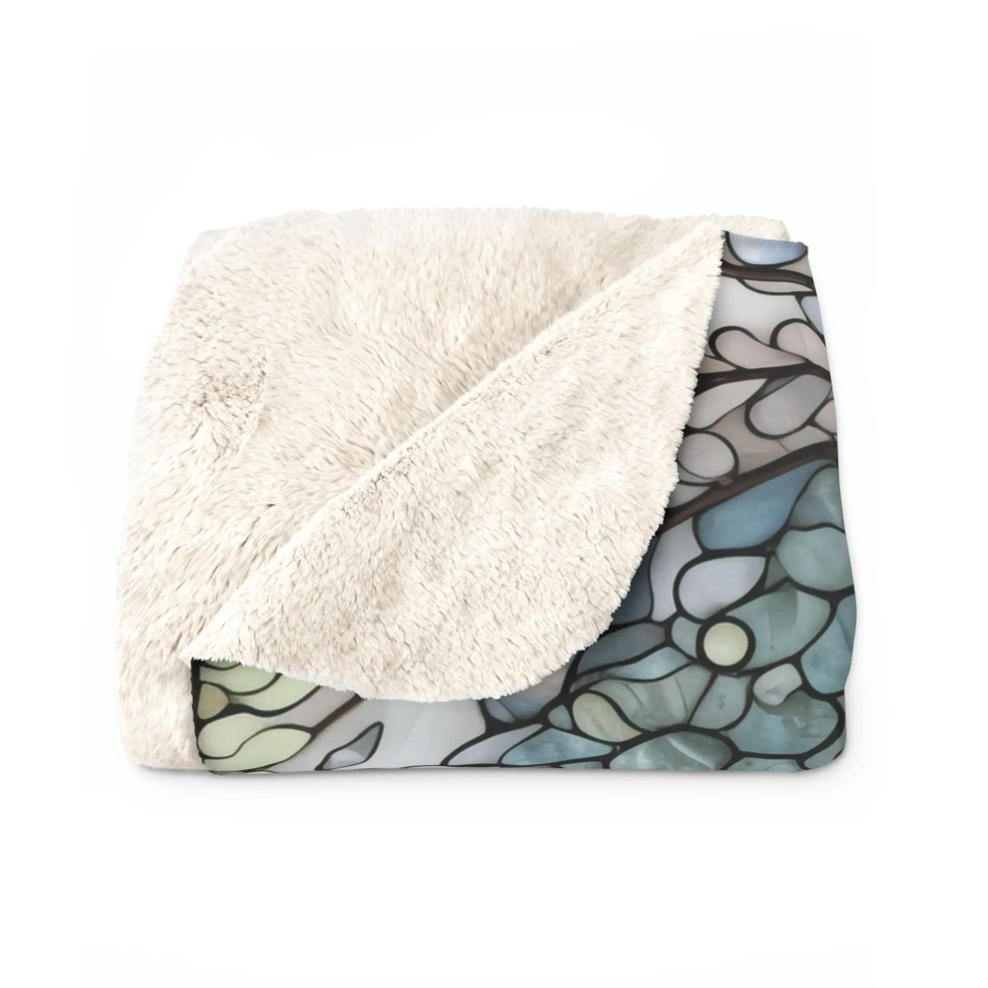 The Stained Glass Nouveau Ferns Sherpa Fleece Blanket, shown folded with one corner flipped, reveals a botanical stained glass-style underside in blue and green, blending comfort with nature-inspired artistry.