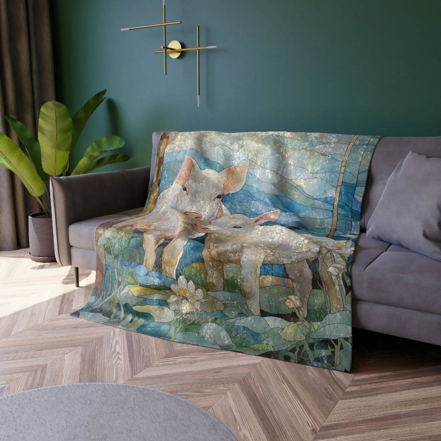A cozy living room with a gray couch draped with a Stained Glass Piglets Crushed Velvet Blanket, featuring colorful imagery. The green walls evoke springtime forest vibes, complemented by a modern gold wall light and potted plant. Dark curtains frame the window, and the floor has a wood herringbone pattern.