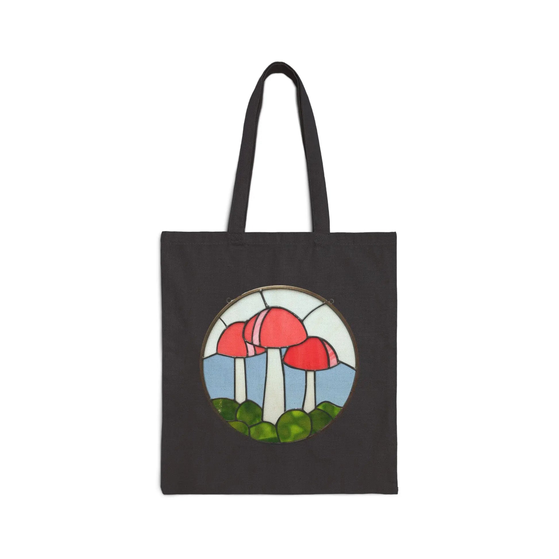 Stained Glass Mushrooms Cotton Canvas Tote Bag with a design of red mushrooms on white stems amid green grass, channeling Noelle Barnes artistic style.