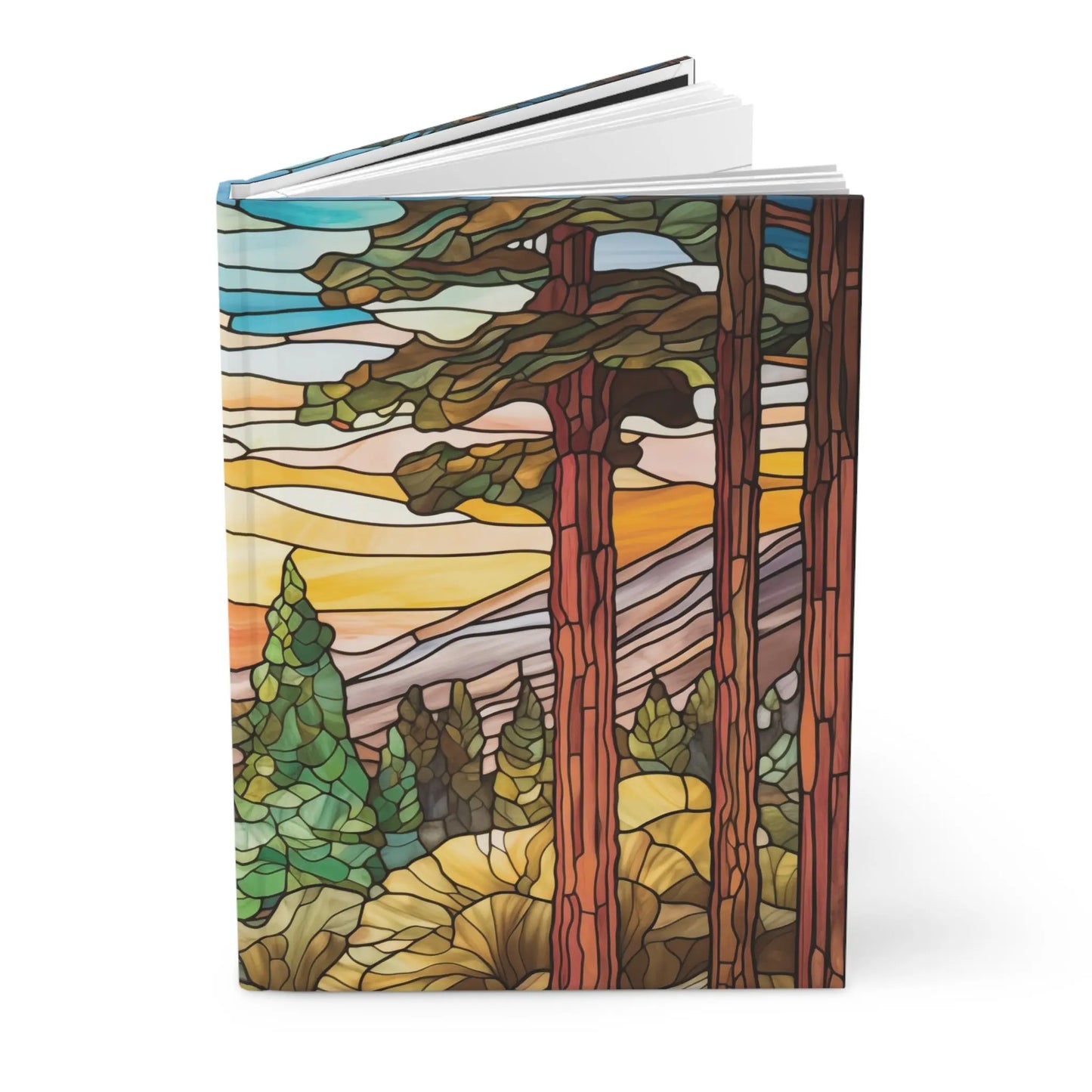 The Stained Glass Sequoia Forest Hardcover Journal features a matte cover with a vibrant illustration of towering trees and a colorful sky in orange, blue, and green, adding an enchanting touch to your bookshelf or workspace.