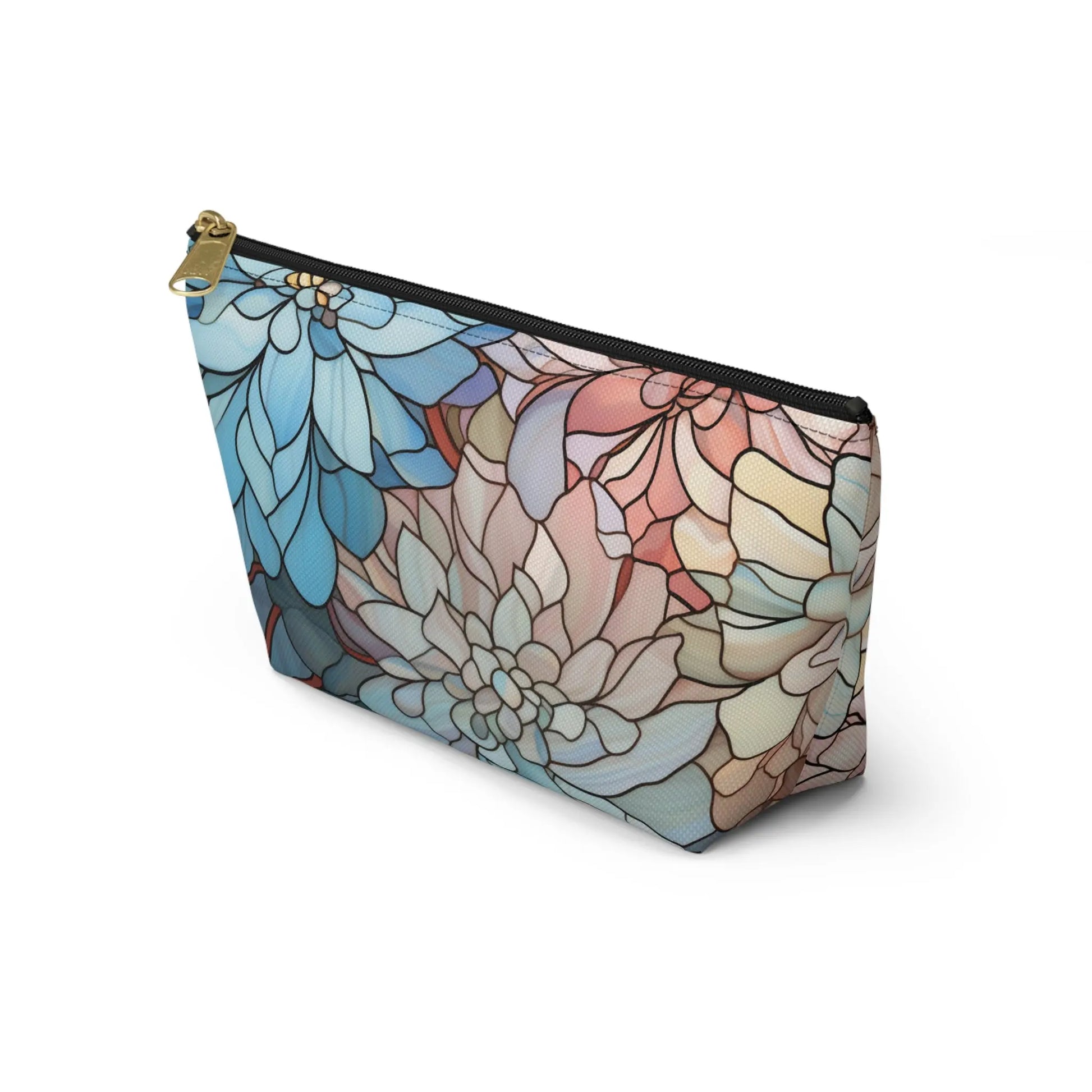 The Stained Glass Dark Flowers Cosmetic Bag features a floral pattern in blue, pink, and beige, resembling artistic stained glass. Its vibrant boho look is complemented by a gold-toned zipper—making it an ideal gift for any occasion.