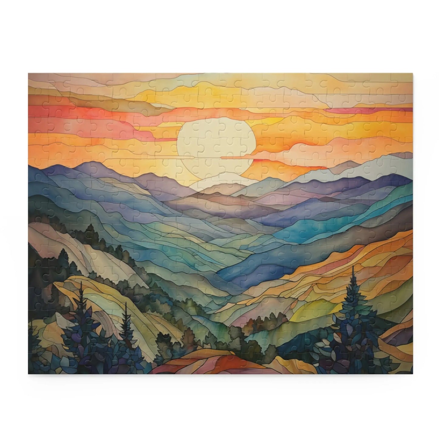 The Sunset Mountains Jigsaw Puzzle is perfect for nature lovers, featuring a serene mountain landscape at sunset with an orange and pink sky, blue and green mountains and valleys, and silhouetted trees in the foreground.