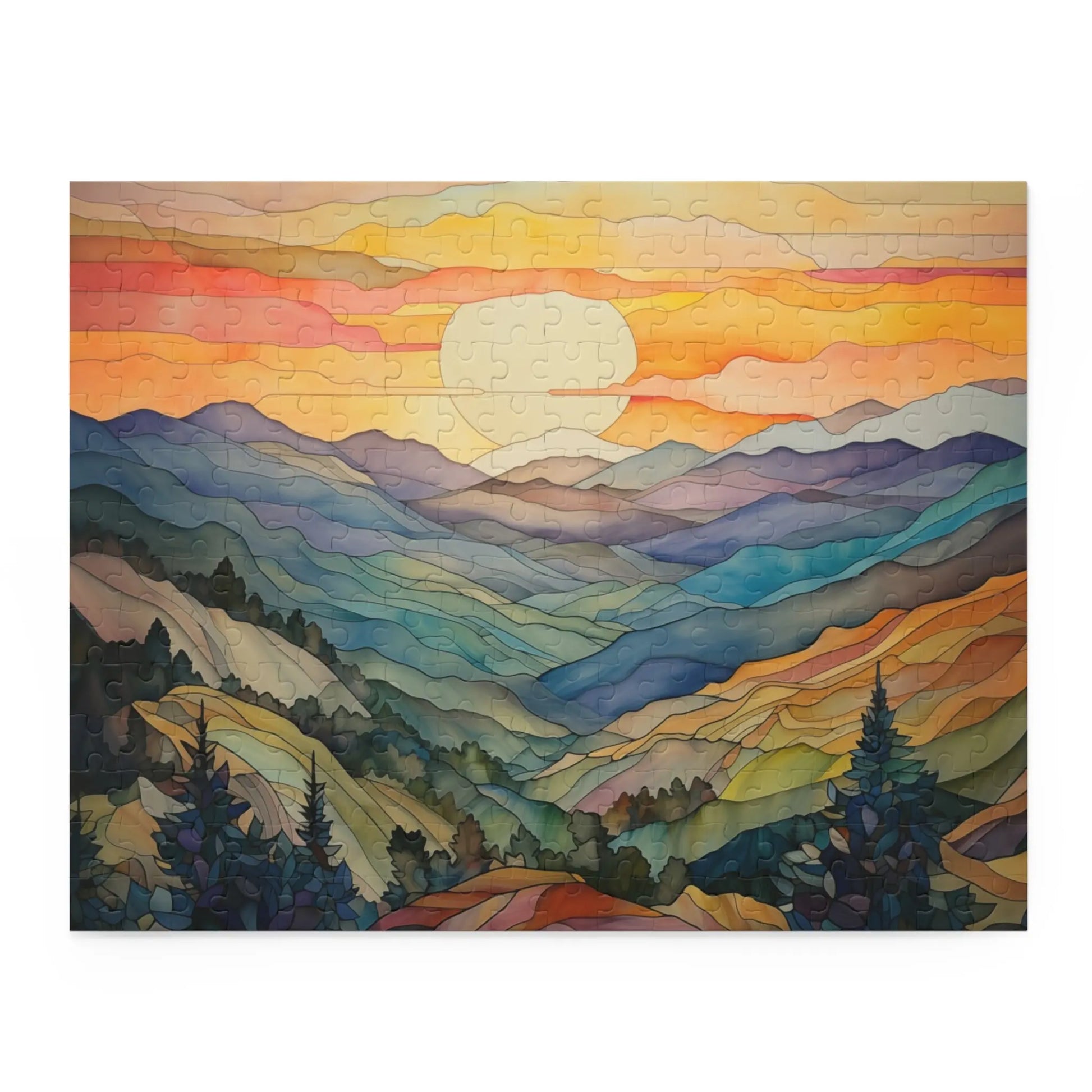The Sunset Mountains Jigsaw Puzzle is perfect for nature lovers, featuring a serene mountain landscape at sunset with an orange and pink sky, blue and green mountains and valleys, and silhouetted trees in the foreground.