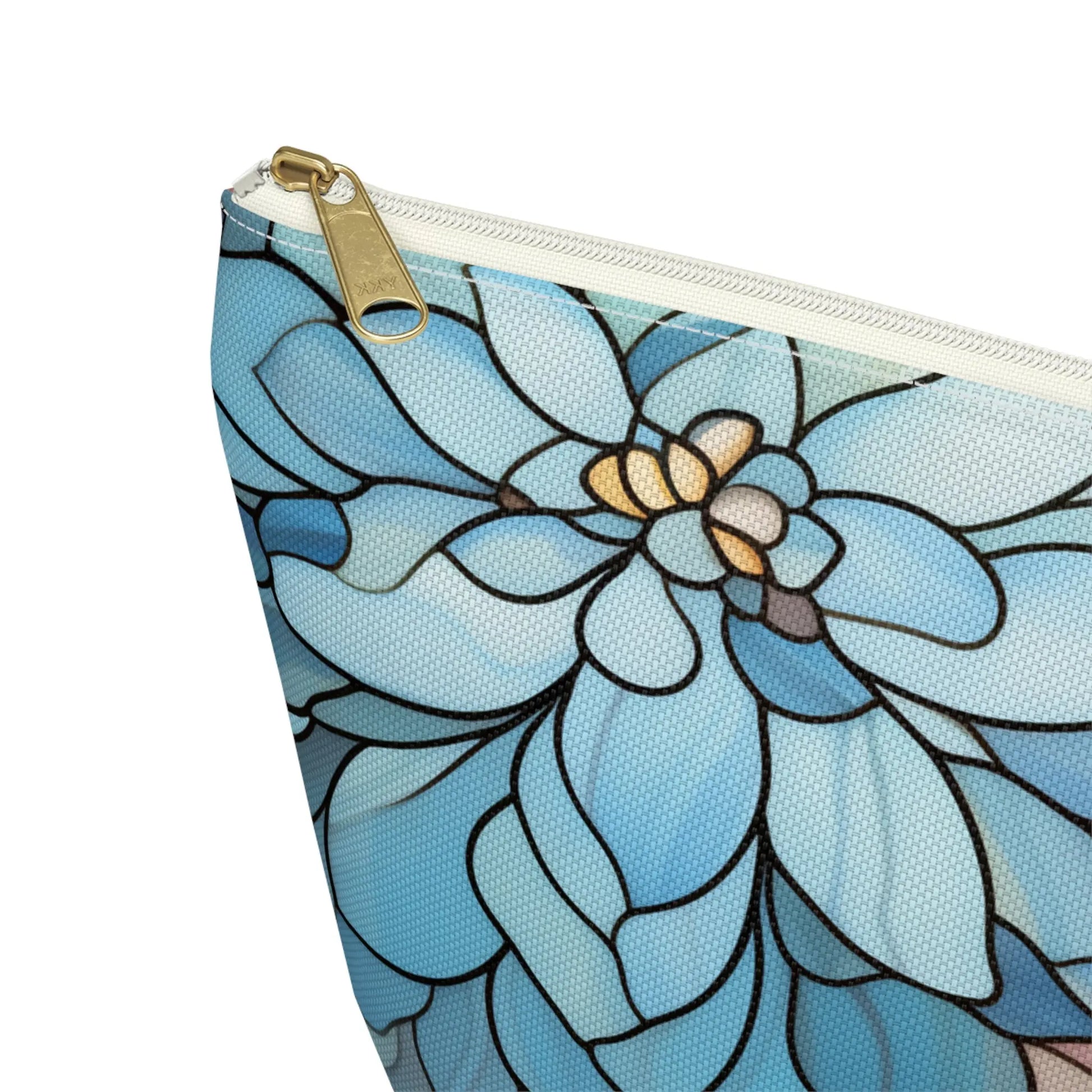 Close-up of the Stained Glass Dark Flowers Cosmetic Bag featuring a blue zippered design with floral patterns in shades of blue, cream, and gray. The gold zipper adds a touch of elegance, making it an ideal boho gift.