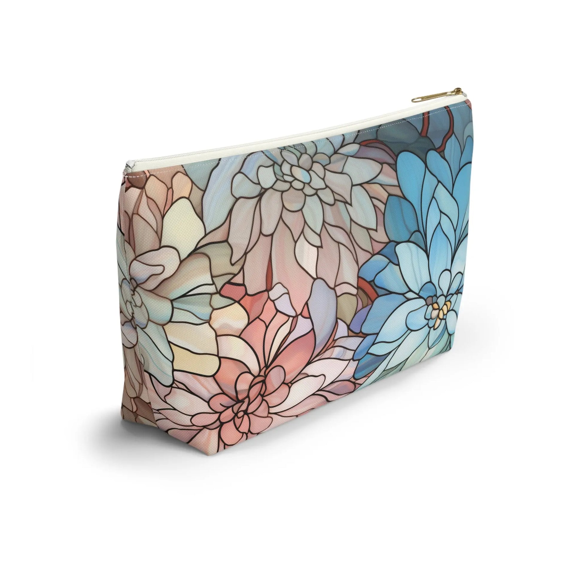 The Stained Glass Dark Flowers Cosmetic Bag is a rectangular zippered pouch with a floral design of large overlapping petals in blue, pink, and beige. It stands upright on a white background, providing an eye-catching boho gift vibe.