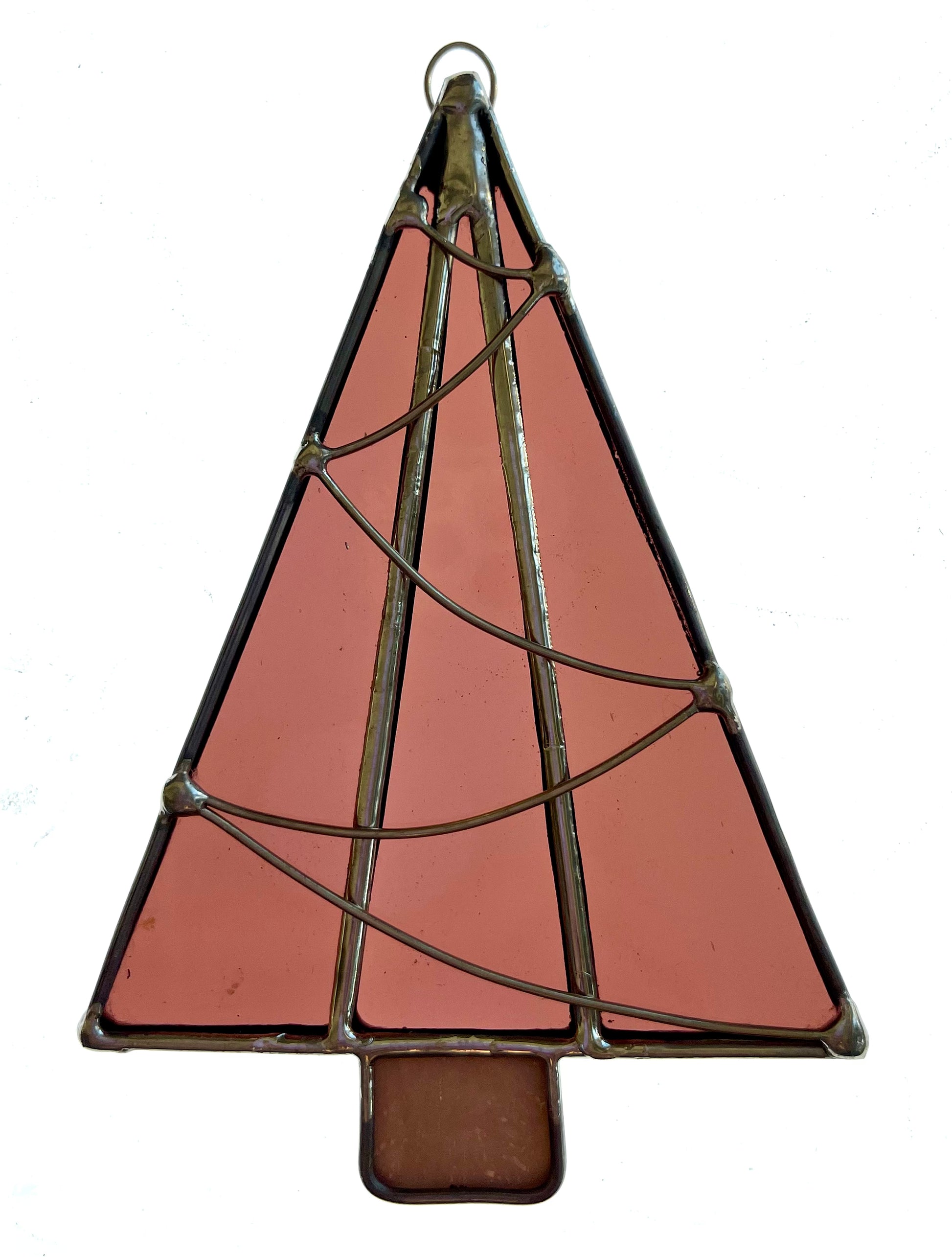 The Handmade Christmas Tree Suncatchers feature pinkish Tiffany-method stained glass panels, outlined in dark metal, with delicate wire details wrapping around the tree.