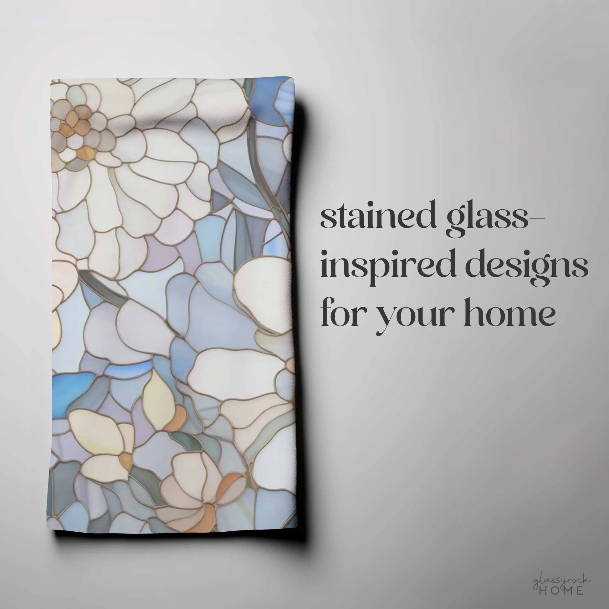 A folded kitchen towel with a stained glass floral design in blue, white, and beige graces the left. Text on the right reads stained glass-inspired designs for your home in elegant font—perfect as a boho gift that adds charm to any space.
