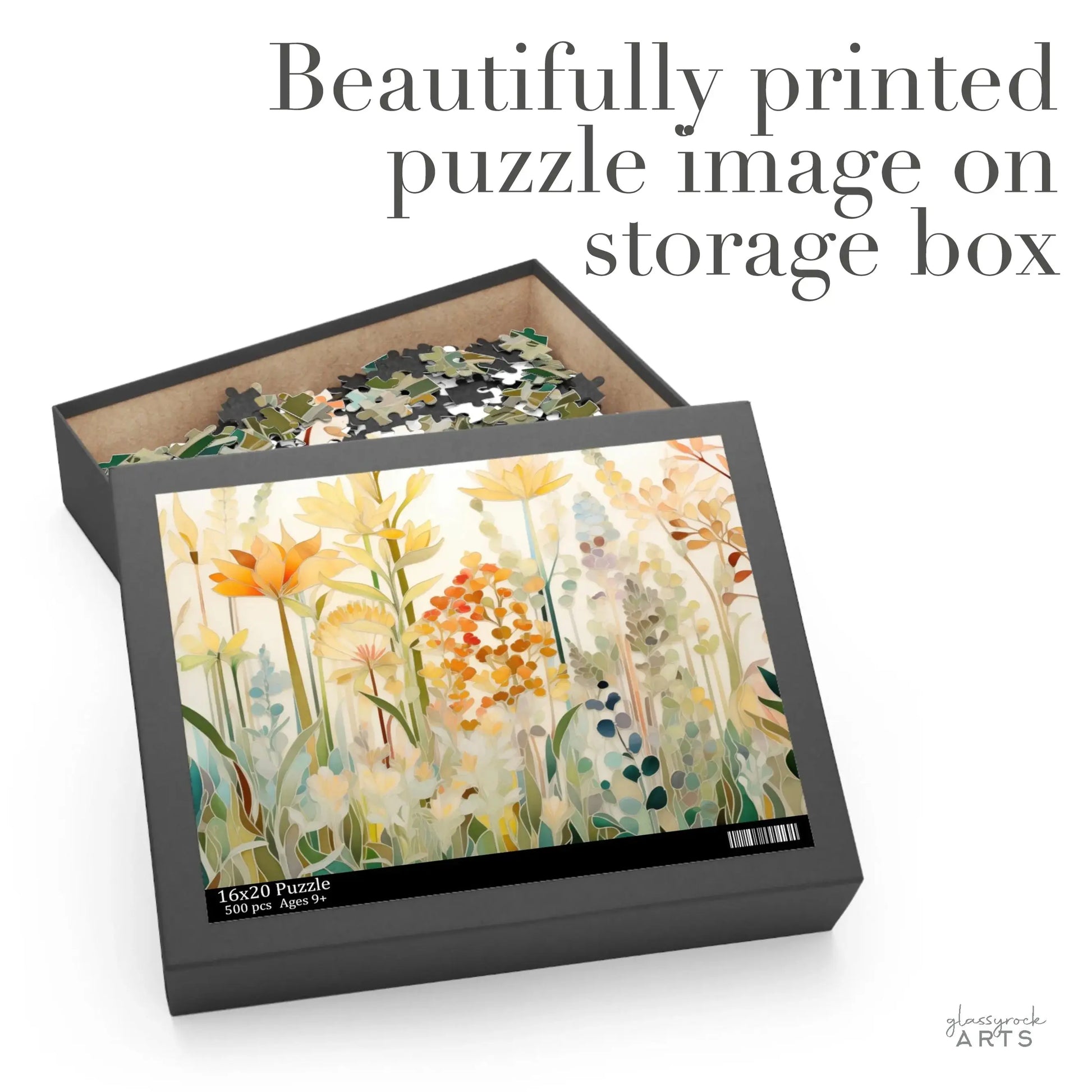 Open box with the Autumn Botanicals Jigsaw Puzzle featuring vibrant flowers, foliage, and leaves in orange, yellow, and green hues. The text above reads: Beautifully printed puzzle image on storage box, and the box displays the same floral design.