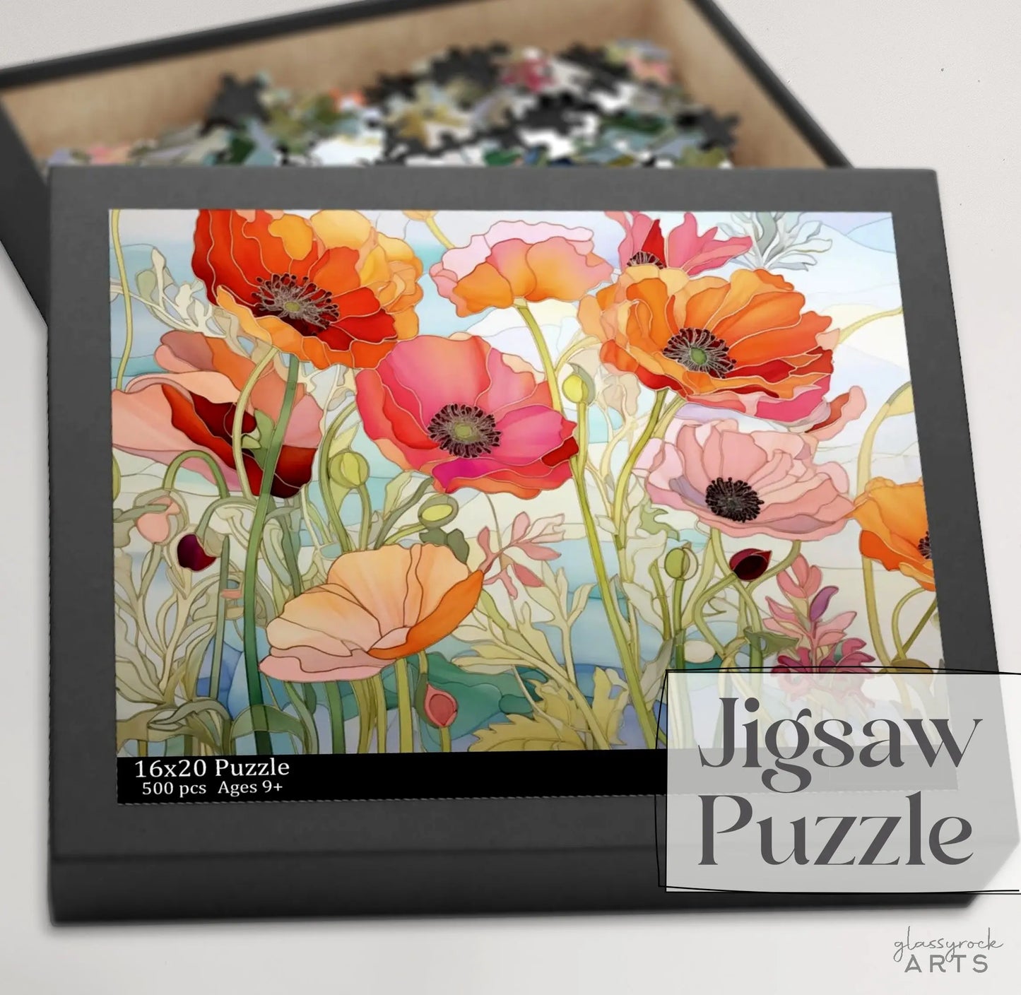 The California Poppies Jigsaw Puzzle is a 500-piece set featuring vibrant orange, red, and pink poppies with green stems. This stained glass-inspired design measures 16x20 inches, suitable for ages 9+, making it an ideal art gift from Glassrock Arts.