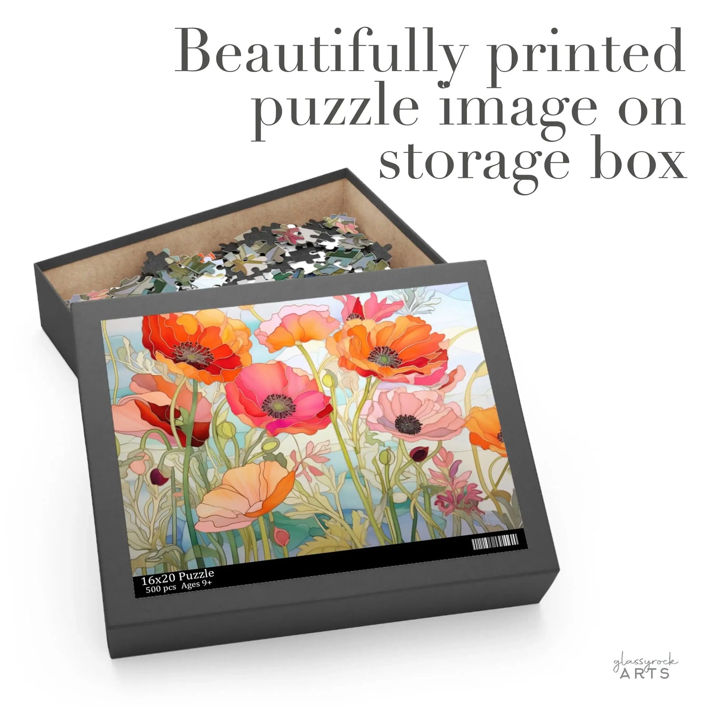 An open box of the California Poppies Jigsaw Puzzle reveals colorful, stained glass-inspired pieces. The lid displays red, pink, and orange blooming poppies with text: Beautifully printed puzzle image on storage box. Ideal art gift for puzzle enthusiasts.