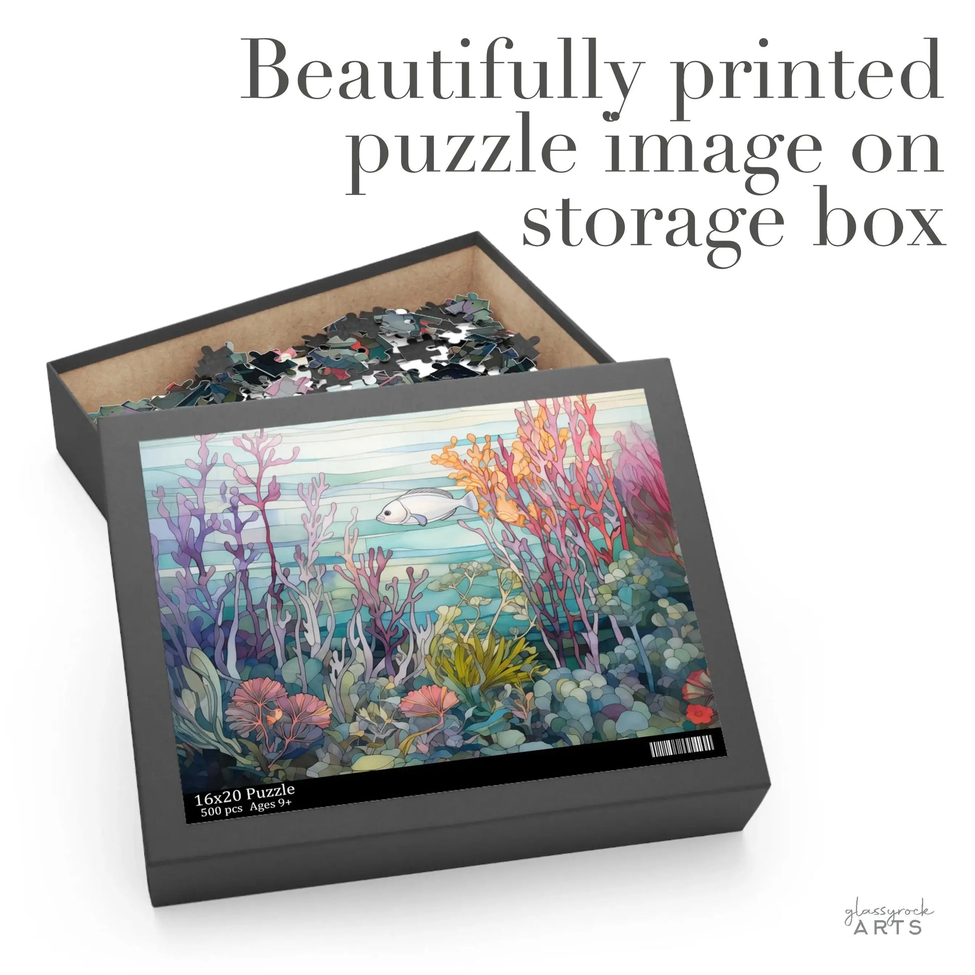 The Coral Reef Ocean Jigsaw Puzzle, partially assembled with vibrant reefs and a white fish, rests in an open box displaying the same image on the lid. The text Beautifully printed puzzle image on storage box suggests its perfect as an art gift.
