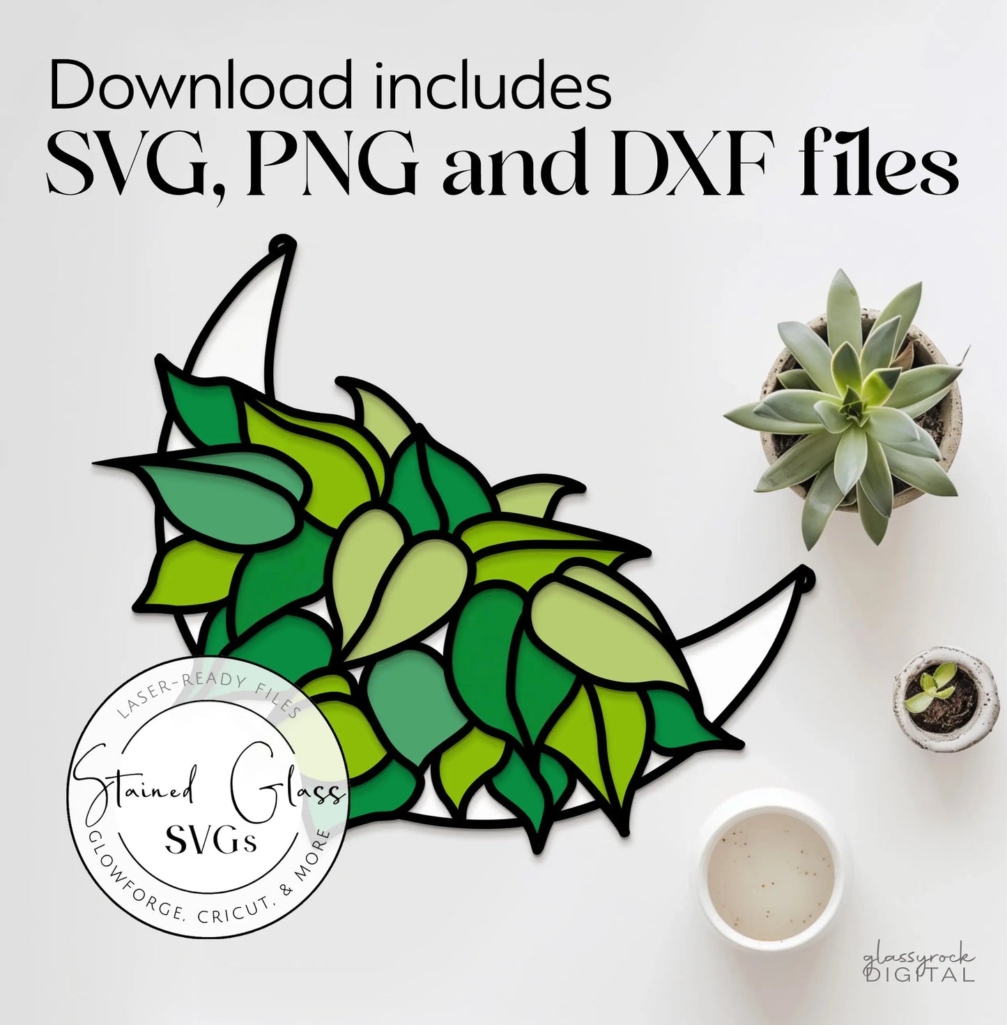 The Stained Glass Philodendron Crescent Moon SVG Files mockup features SVG, PNG, and DXF files with a crescent moon and green leaf design. Perfect for laser cutting enthusiasts, its shown on a white surface next to a succulent plant and small decor items.