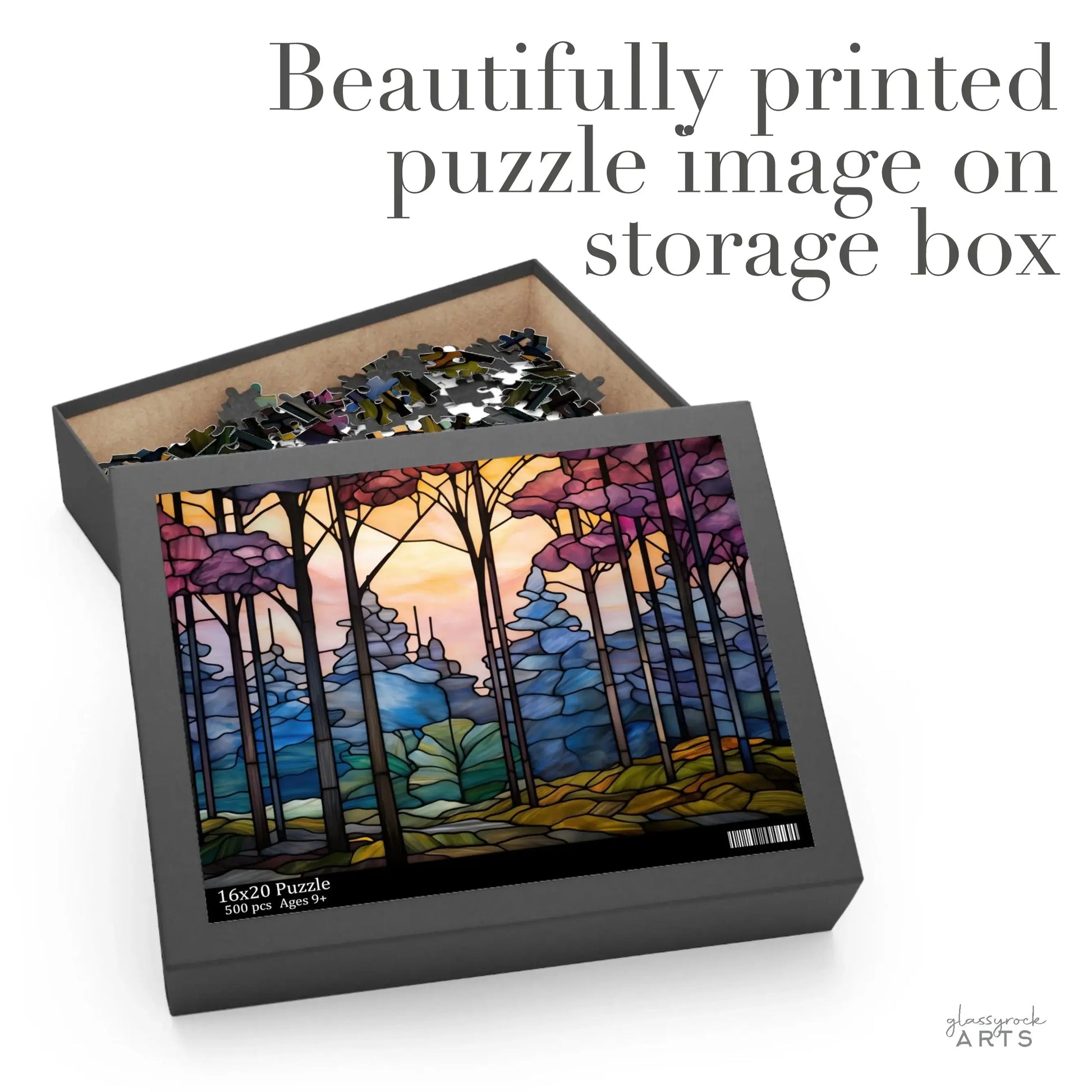 The Dark Woods Forest Jigsaw Puzzle box showcases a vibrant stained glass-style image of a dark forest with hills. The open lid displays puzzle pieces inside, with text stating, Beautifully printed puzzle image on storage box, making it perfect for art enthusiasts.