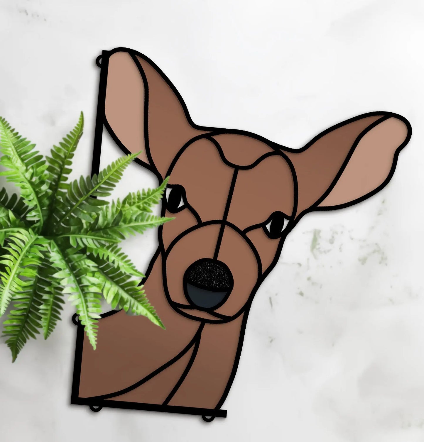 The Stained Glass Deer Buddy SVGs features a brown deer head with black outlines beside a green fern on a light background, available as an easy-to-replicate stained glass pattern.