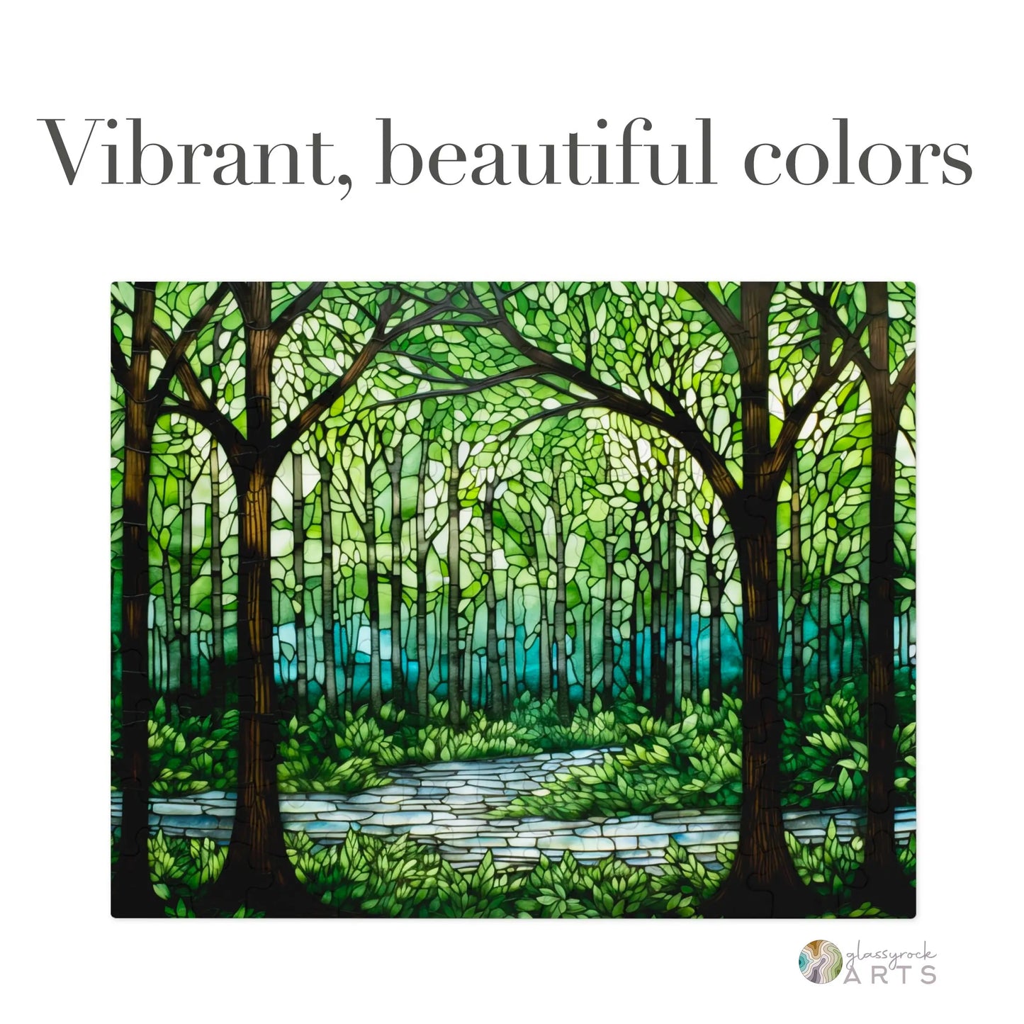 A stained glass artwork called the Stained Glass Forest Jigsaw Puzzle depicts a lush forest with tall trees and a winding path. The vibrant greens and blues highlight the foliage and sky, creating a serene atmosphere. Text above reads, Vibrant, beautiful colors.