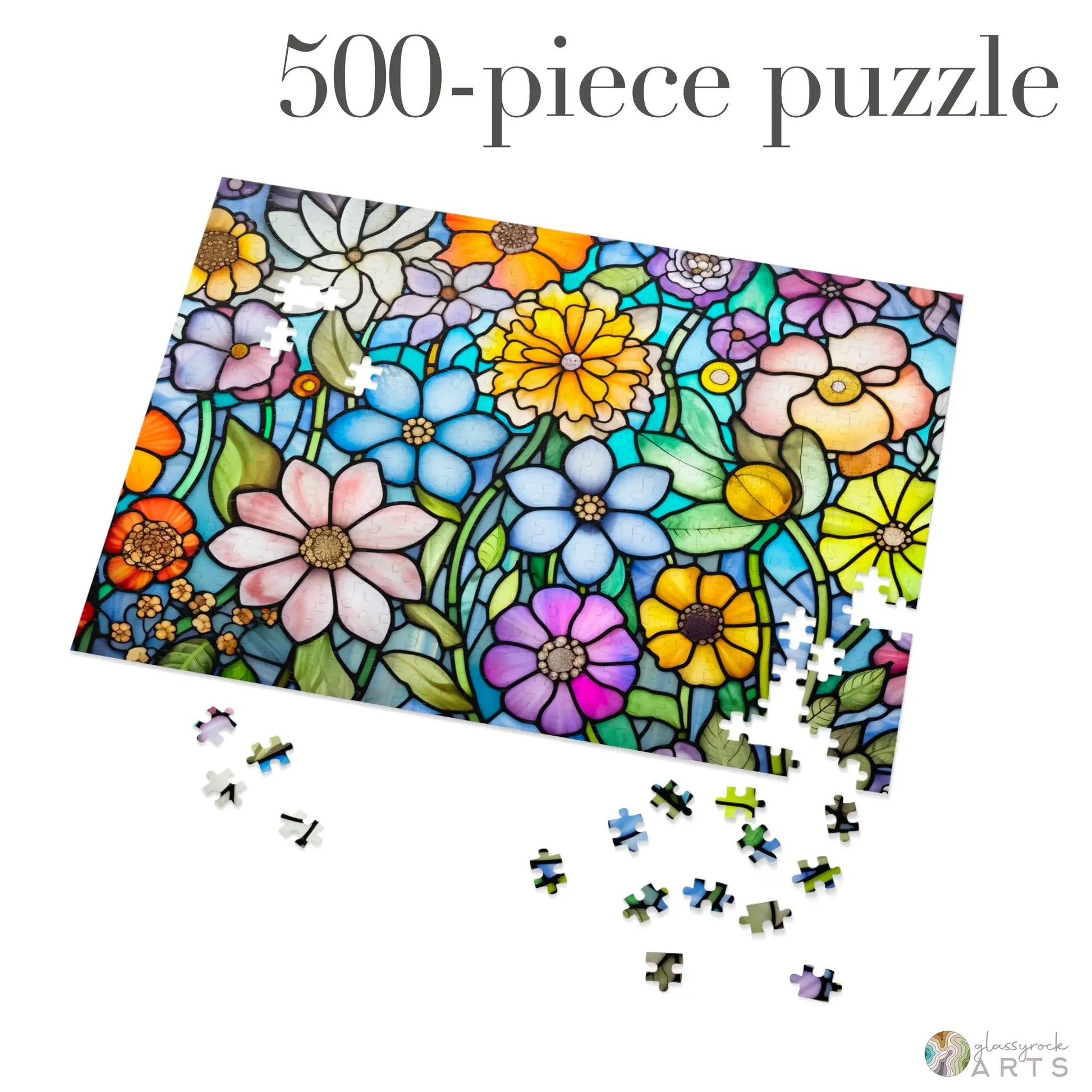 The Stained Glass Flower Garden Jigsaw Puzzle, a 500-piece set, features a vibrant stained glass image of colorful flowers and greenery on high-quality chipboard. Several pieces are scattered for completion, making it an ideal gift for puzzle enthusiasts.