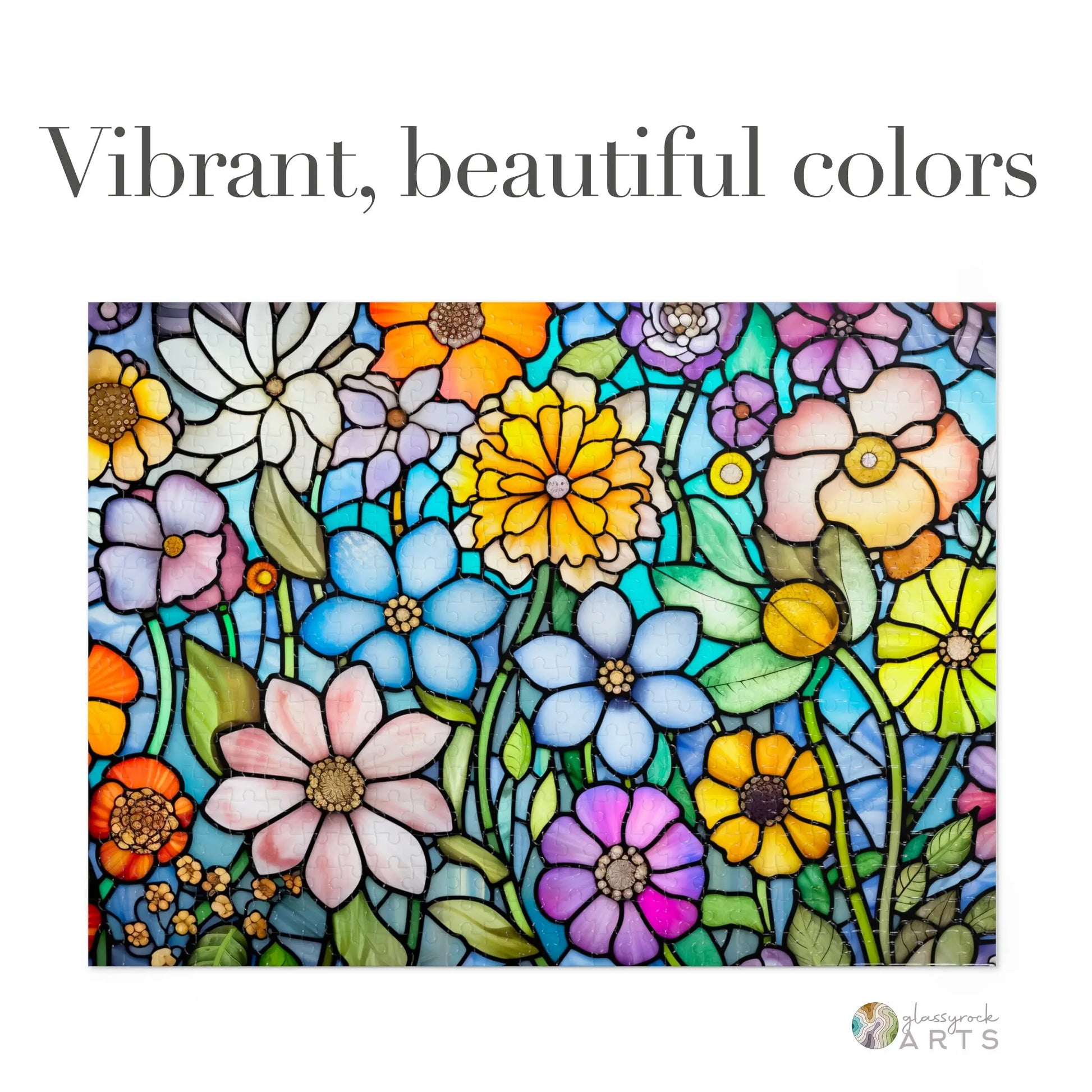 The Stained Glass Flower Garden Jigsaw Puzzle features a vibrant array of blue, pink, yellow, and purple flowers with green leaves, showcasing intricate designs that captivate the eye.