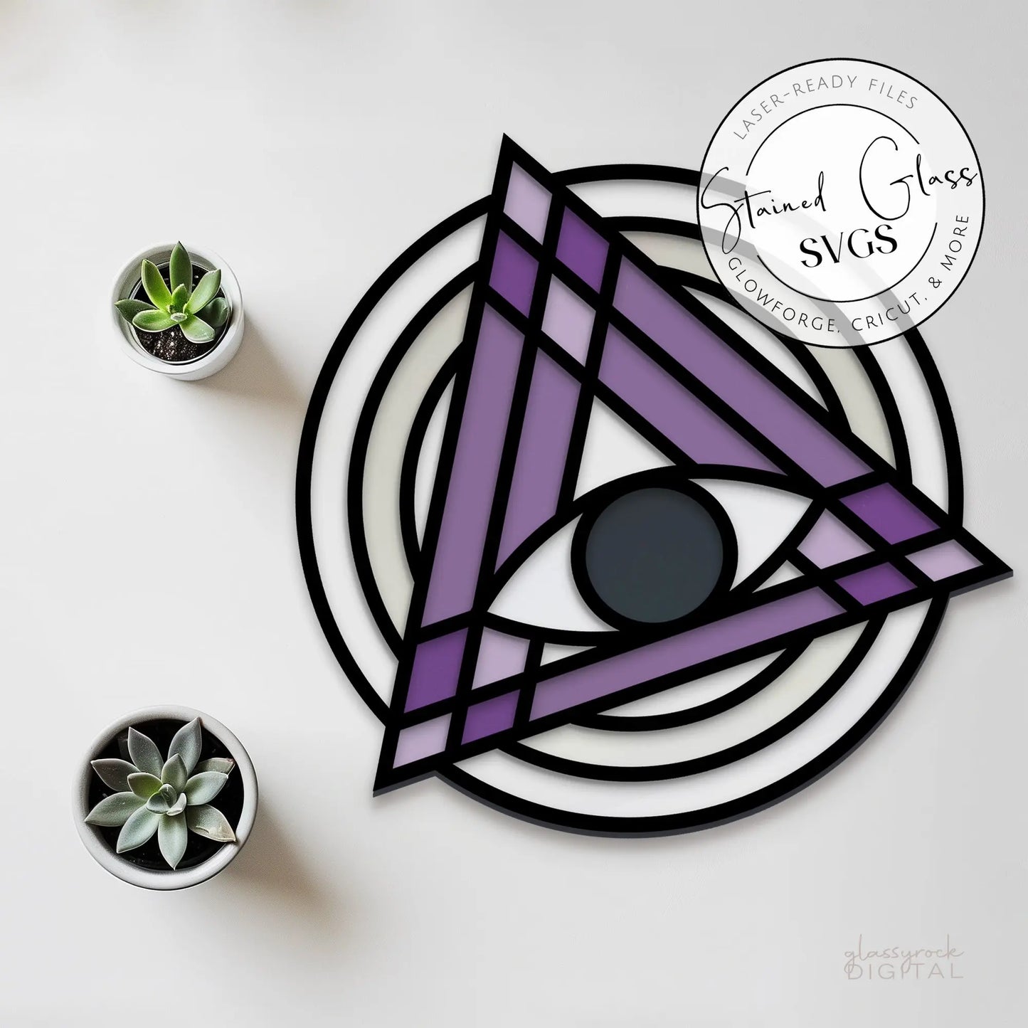Adorn any space with the Stained Glass Evil Eye Suncatcher SVGs, featuring a central eye in a faux stained glass design within a purple triangle and black and white circular backdrop. Complemented by three potted succulents, it adds an artistic flair to your decor.