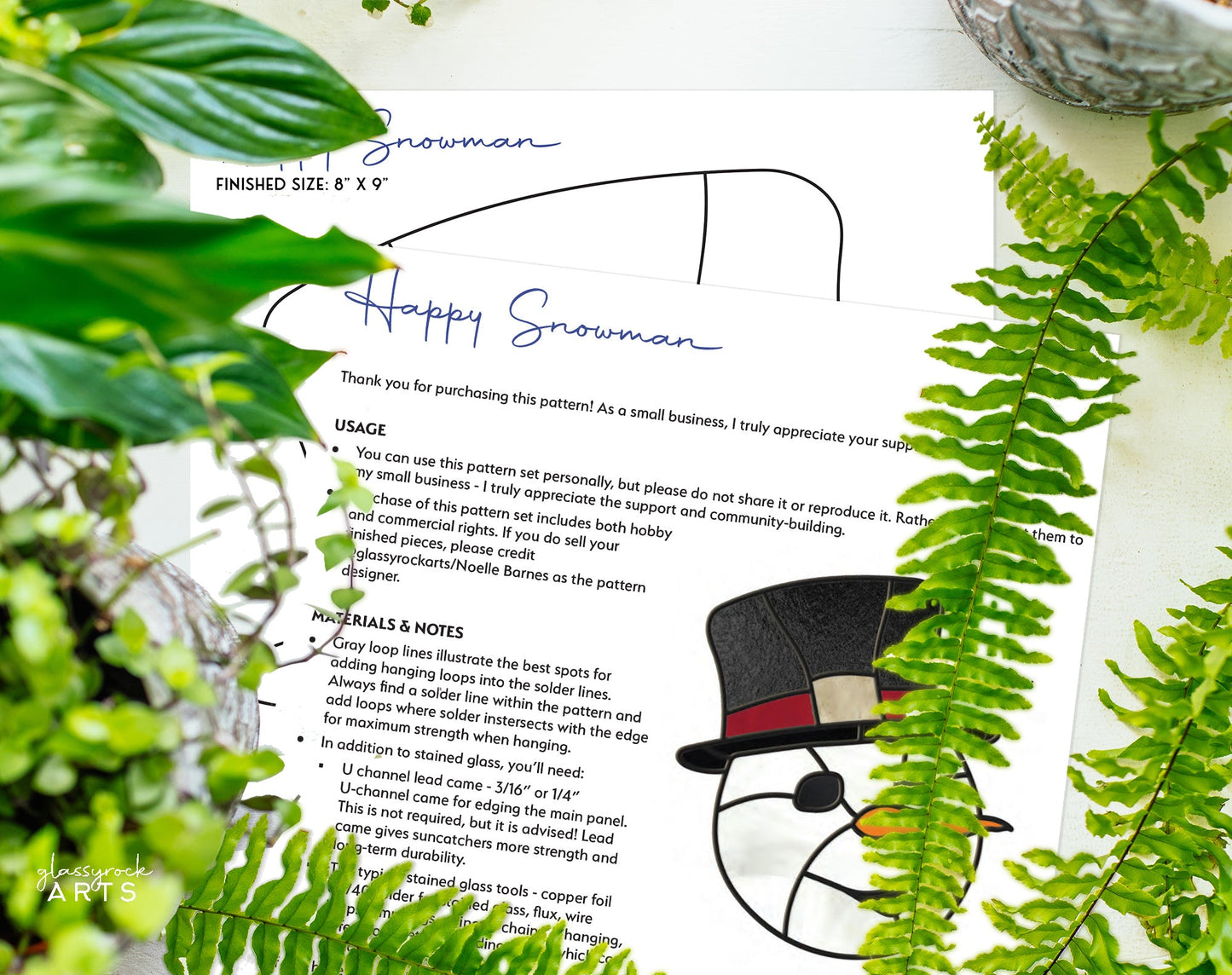 The Snowman Stained Glass Pattern showcases Happy Snowman text with green leaves. A cozy snowman with a black hat and red band sparkles like stained glass. Available as an 8 x 9 digital download for the Christmas season.