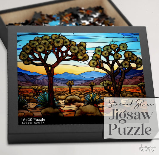 This art gift, the Joshua Tree National Park Jigsaw Puzzle, features a 500-piece puzzle for ages 9 and up with a stained glass scene of desert landscapes, vibrant skies, majestic mountains, and iconic Joshua trees.