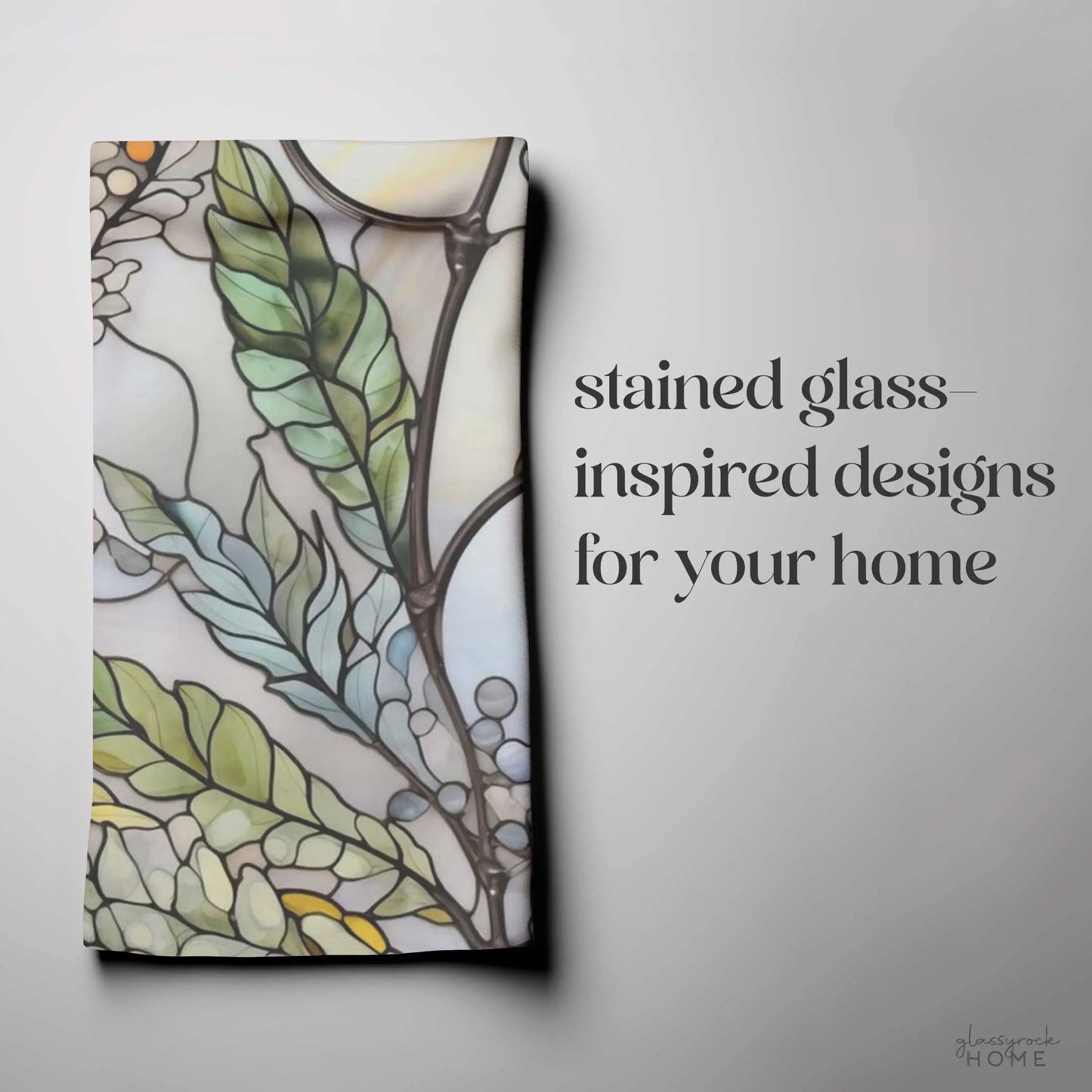 The Stained Glass Nouveau Ferns Dish Towel showcases a stained glass-inspired leaf and floral design in green, blue, and orange against a light background, with the text: Stained glass ferns: custom creations for your home.