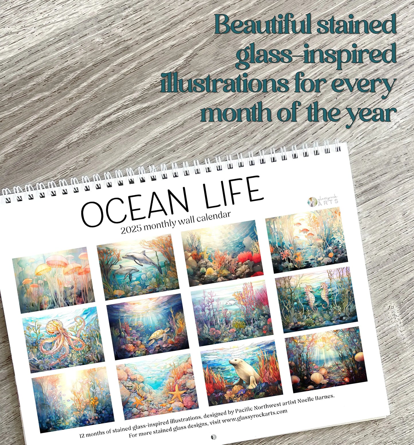 The 2025 Ocean Life Wall Calendar features 12 stained glass-inspired ocean art illustrations set on a wooden surface, with the text: Beautiful stained glass-inspired ocean illustrations for every month of the year.