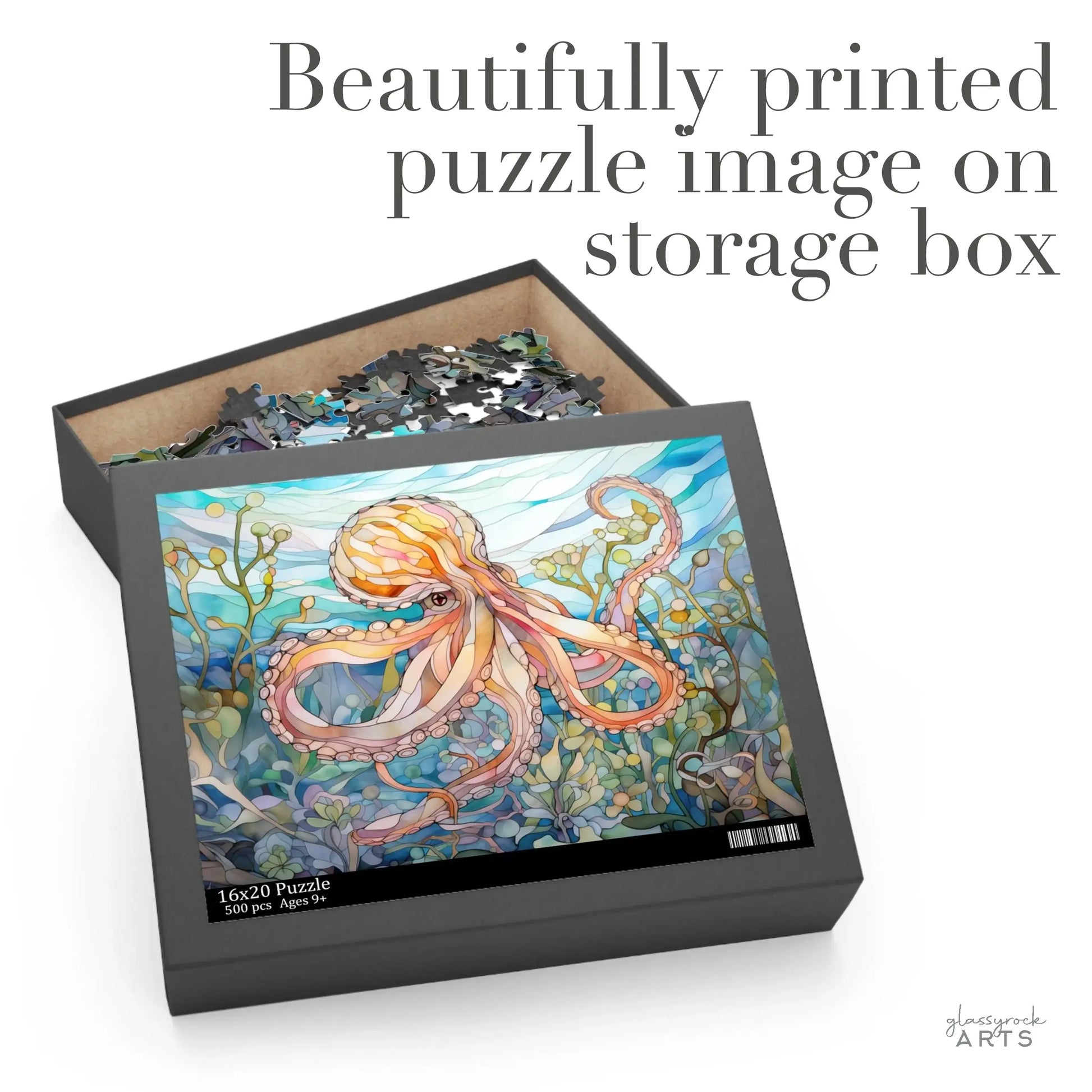 The Stained Glass Octopus Jigsaw Puzzle features an open box with pieces inside, embellished by an octopus among seaweed and blue water. The artful print on the storage box makes this puzzle a stunning ocean-themed gift.