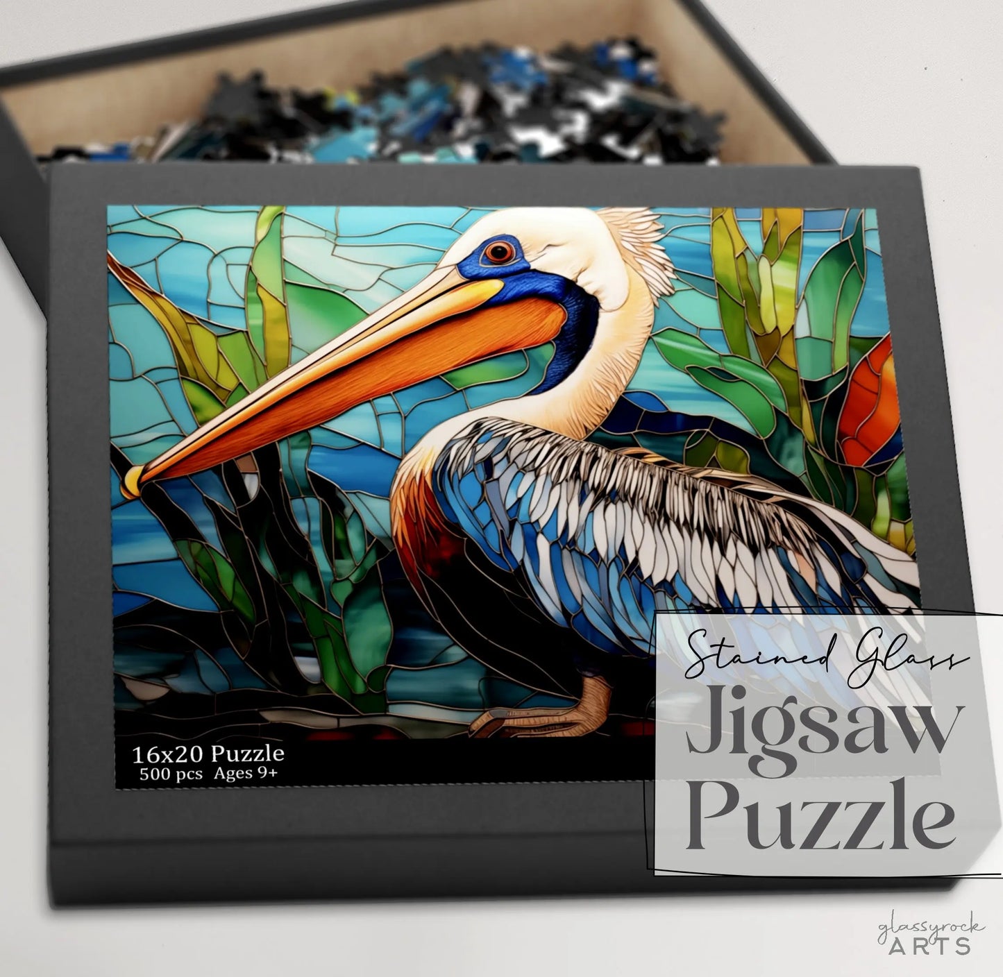 The Stained Glass Pelican Jigsaw Puzzle is a 500-piece art gift featuring a pelican and vibrant abstract shapes, fitting dimensions of 16x20 inches. Suitable for ages 9 and up, its perfect for couples to enjoy together.