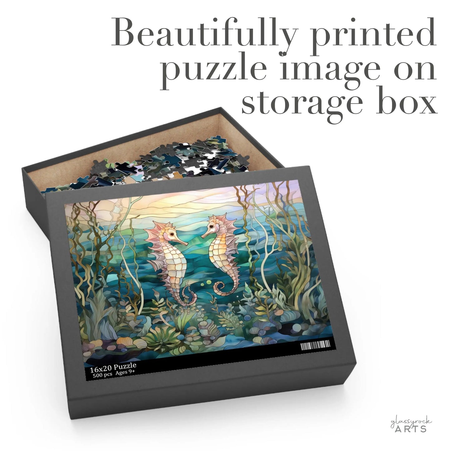 A partially completed Stained Glass Seahorses Jigsaw Puzzle, with pieces scattered around the box, shows two seahorses in an underwater scene with plants. Beautifully printed puzzle image on storage box, reads the text.
